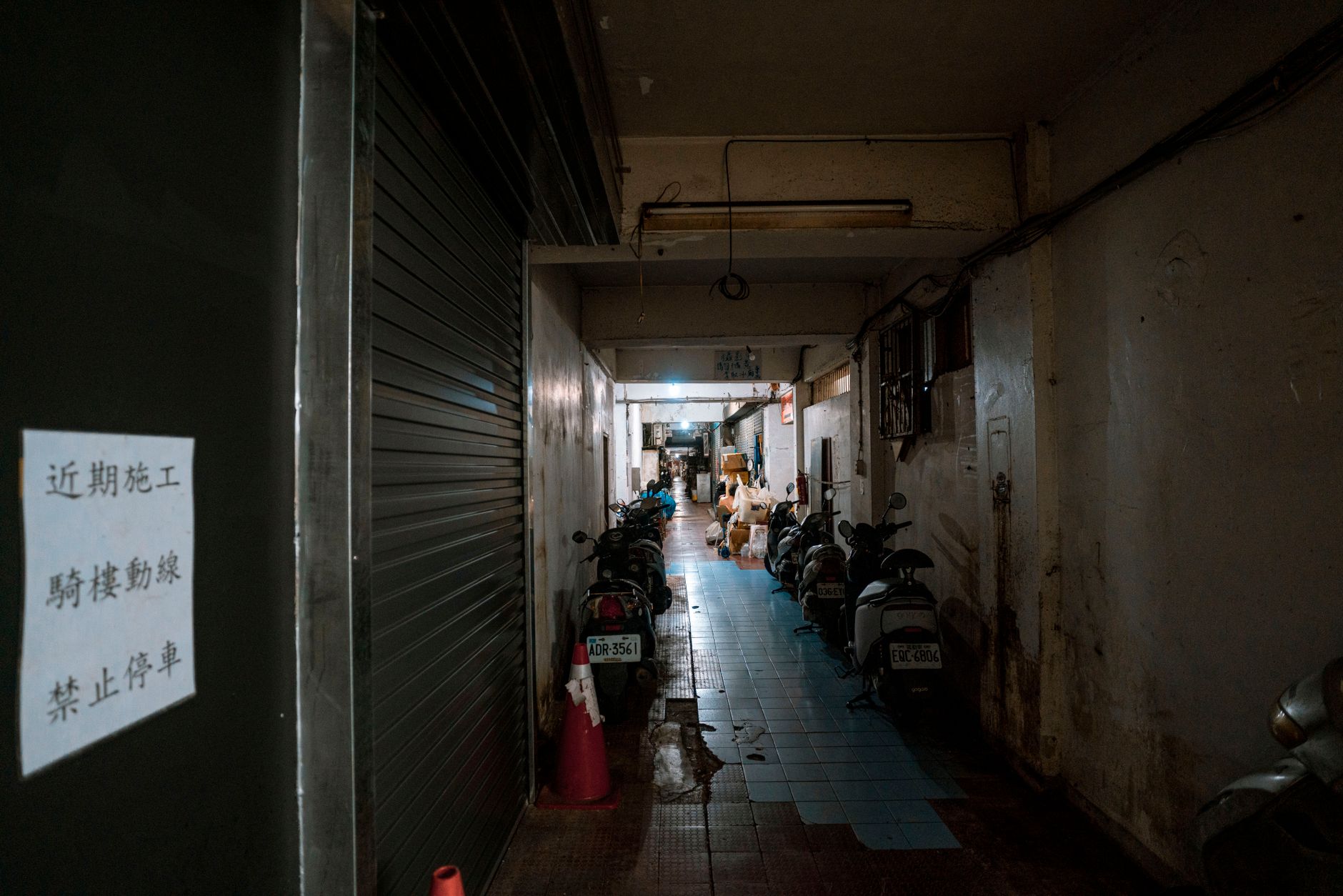 A narrow indoor corridor where bidirectional traffic and blind corners often create AMR congestion.