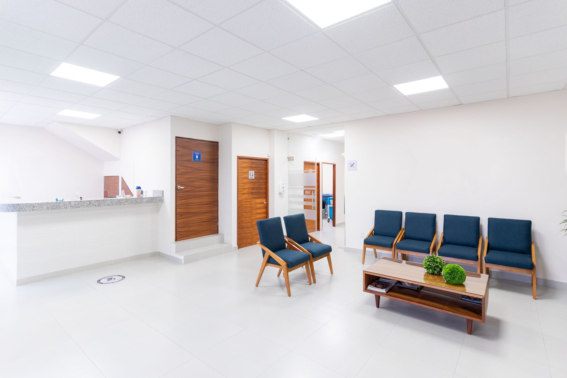 Clinic entrance and lobby circulation area where arrival and departure waves can disrupt a poorly timed overnight or daytime cleaning route.
