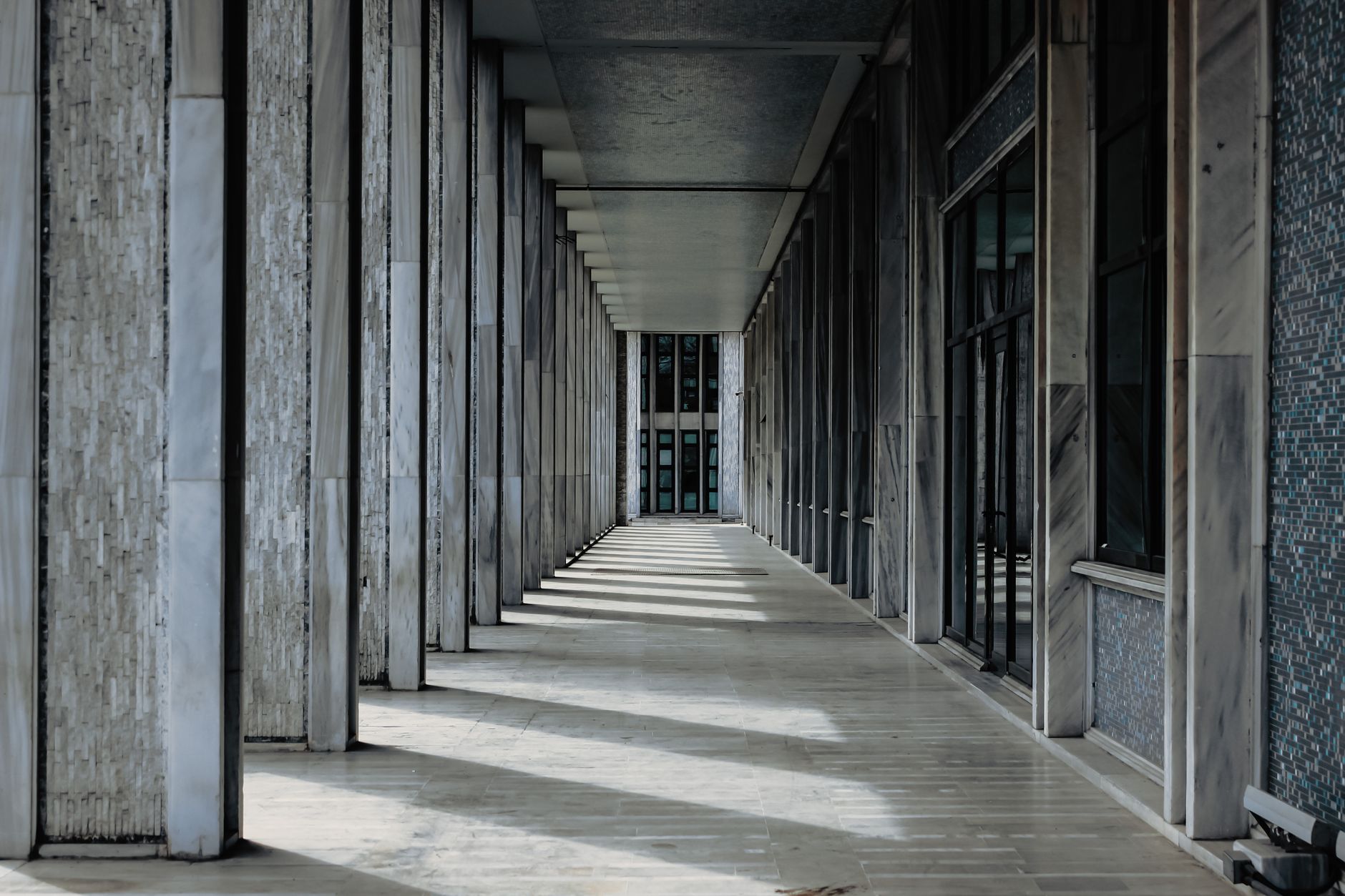 A wide polished hallway or lobby floor that reflects the kind of repeatable hard-floor route suited to a courthouse pilot.