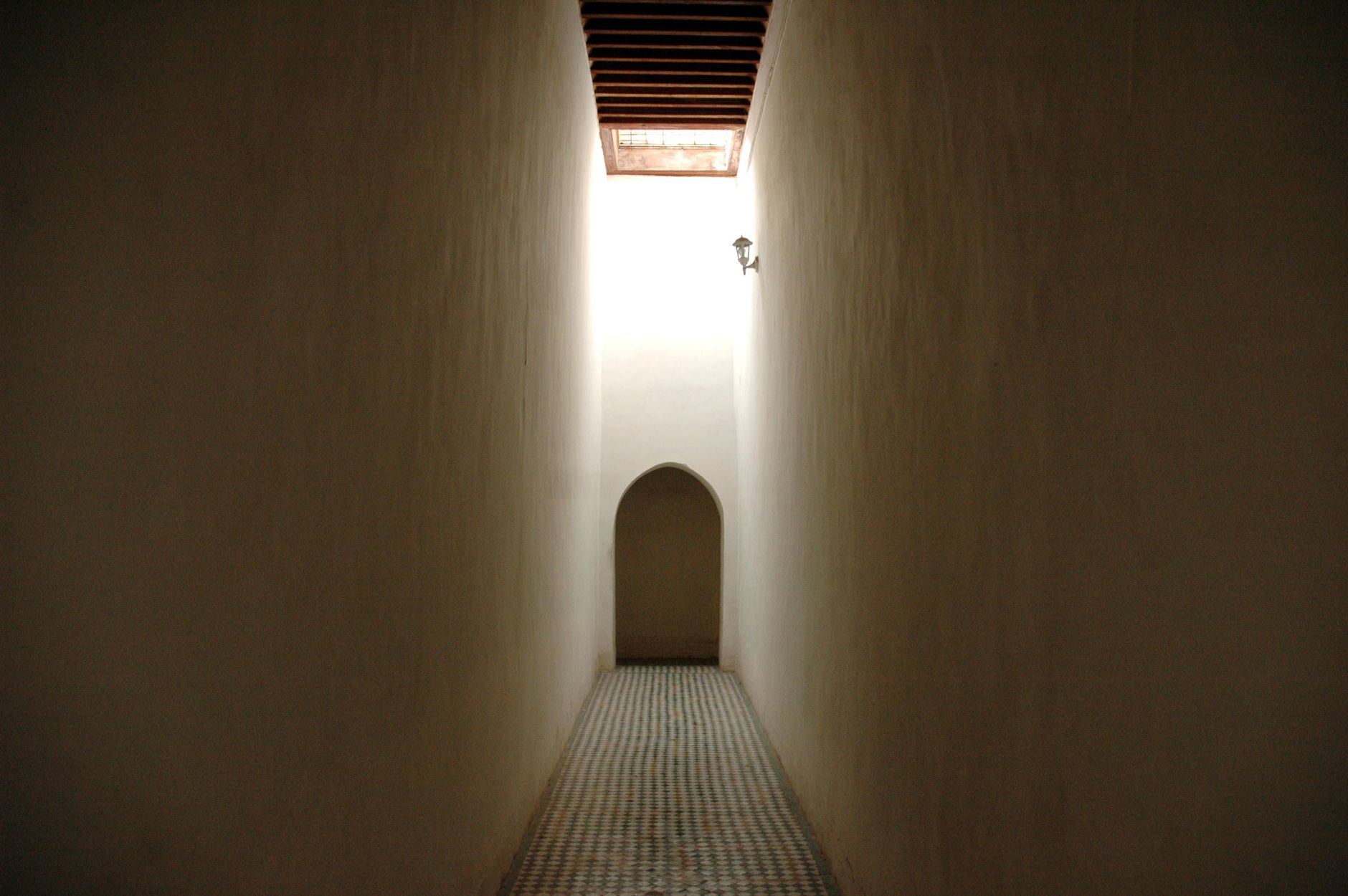 A courthouse-style corridor with tight clearances and furniture pinch points that can complicate floor-cleaning routes.