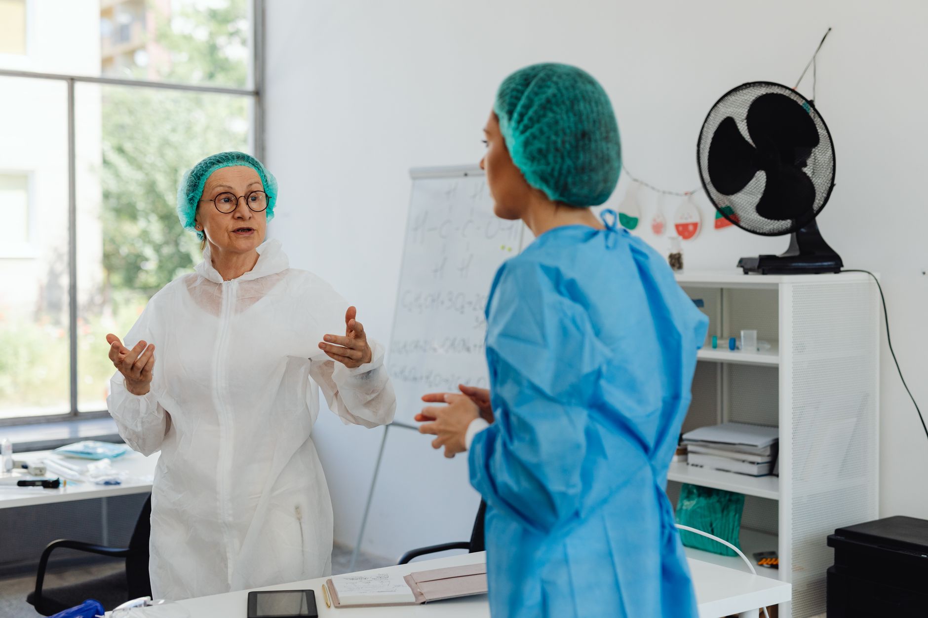 Hospital staff holding a brief team discussion before introducing a new delivery workflow.