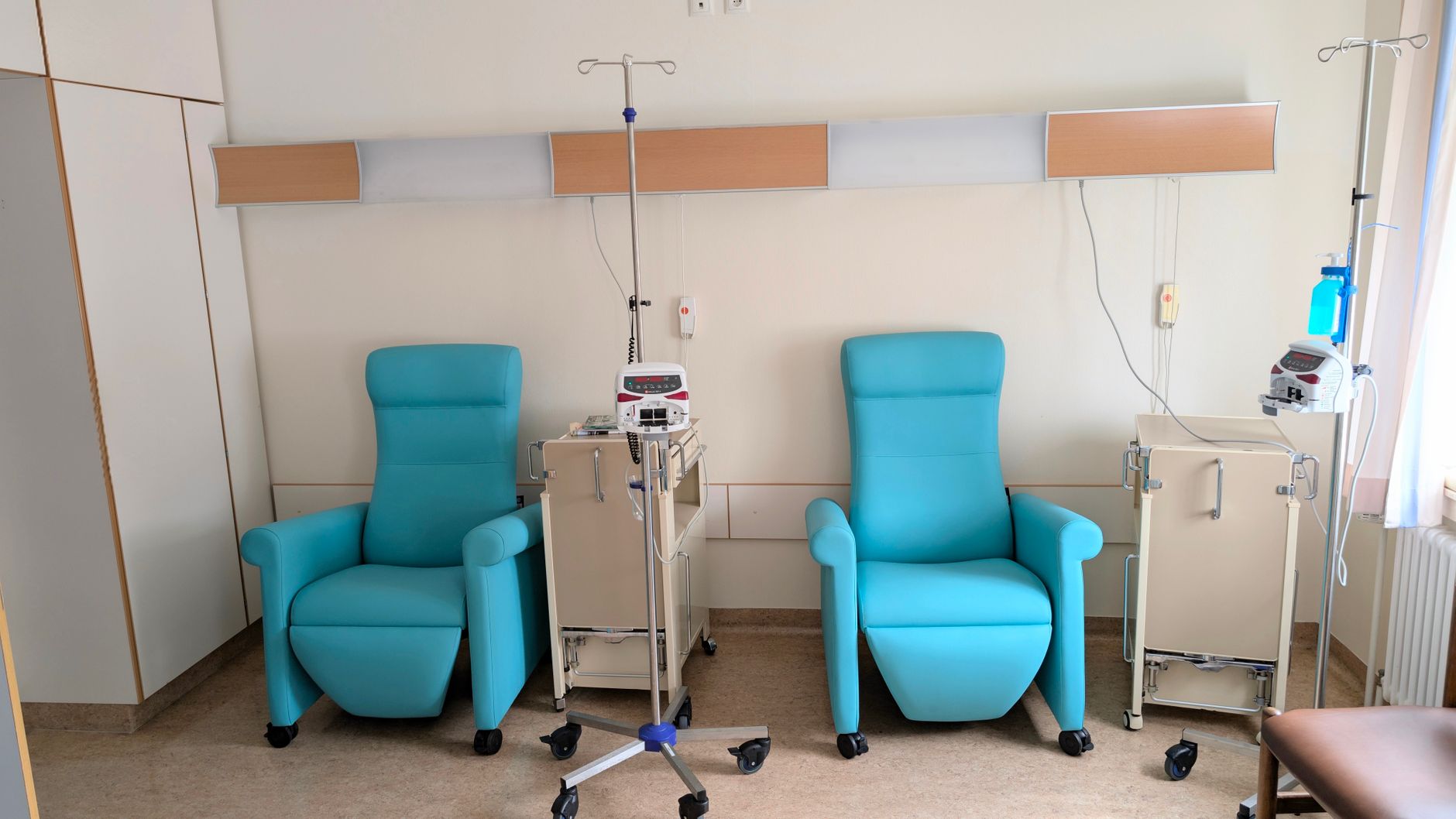 Rows of infusion chairs in a quiet outpatient treatment area show the predictable, bounded environment that suits a first delivery pilot.