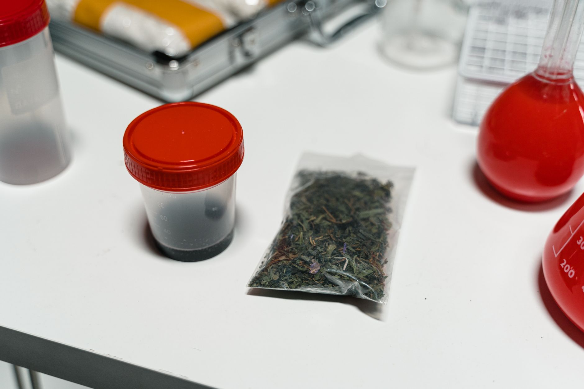 A sealed clinical specimen container underscores the privacy, labeling, and controlled-transport rules that shape infusion-center workflows.