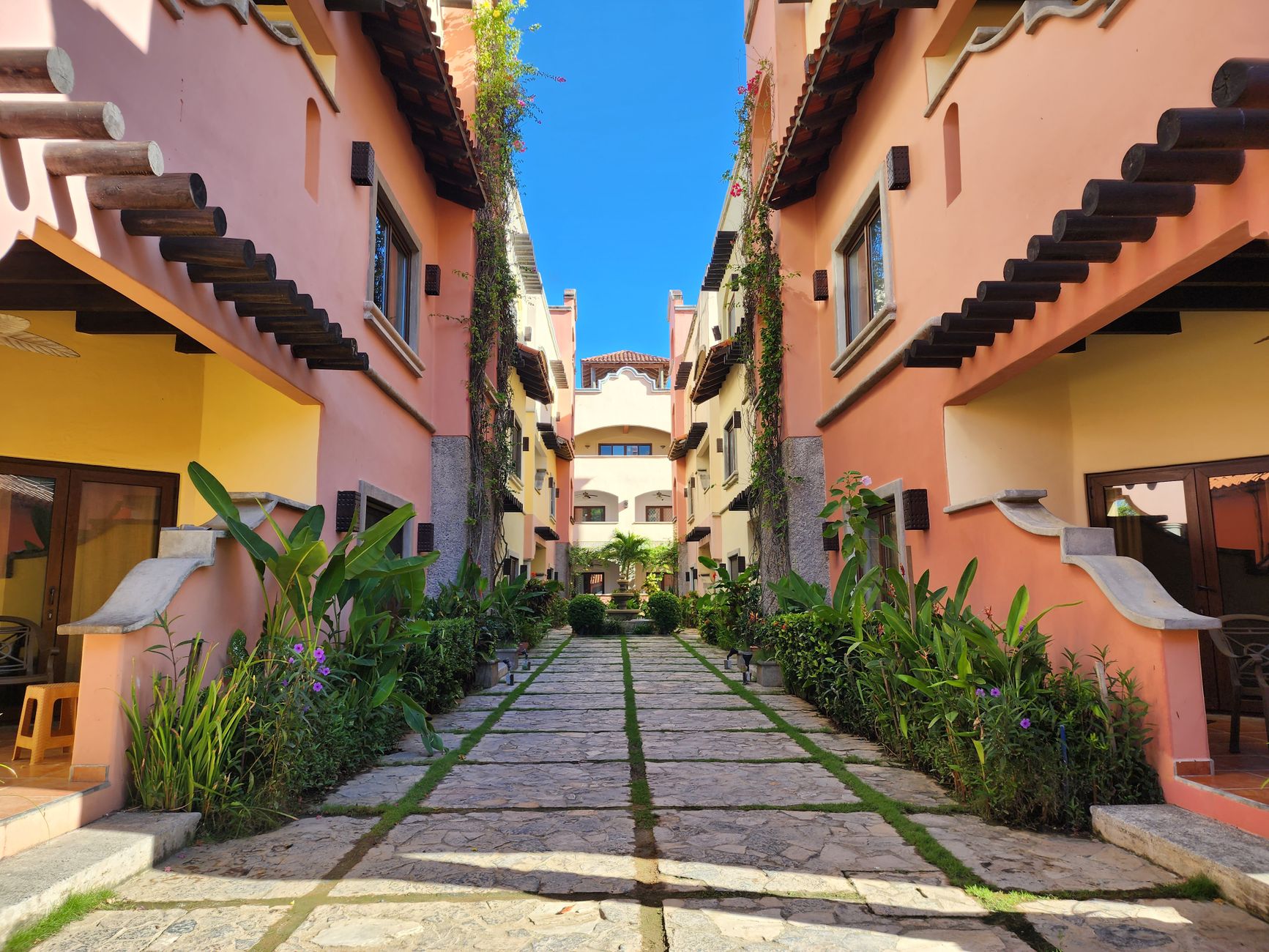 Landscaped resort pathways connecting guest buildings and amenities, showing the kind of outdoor routes a delivery program would have to handle reliably.