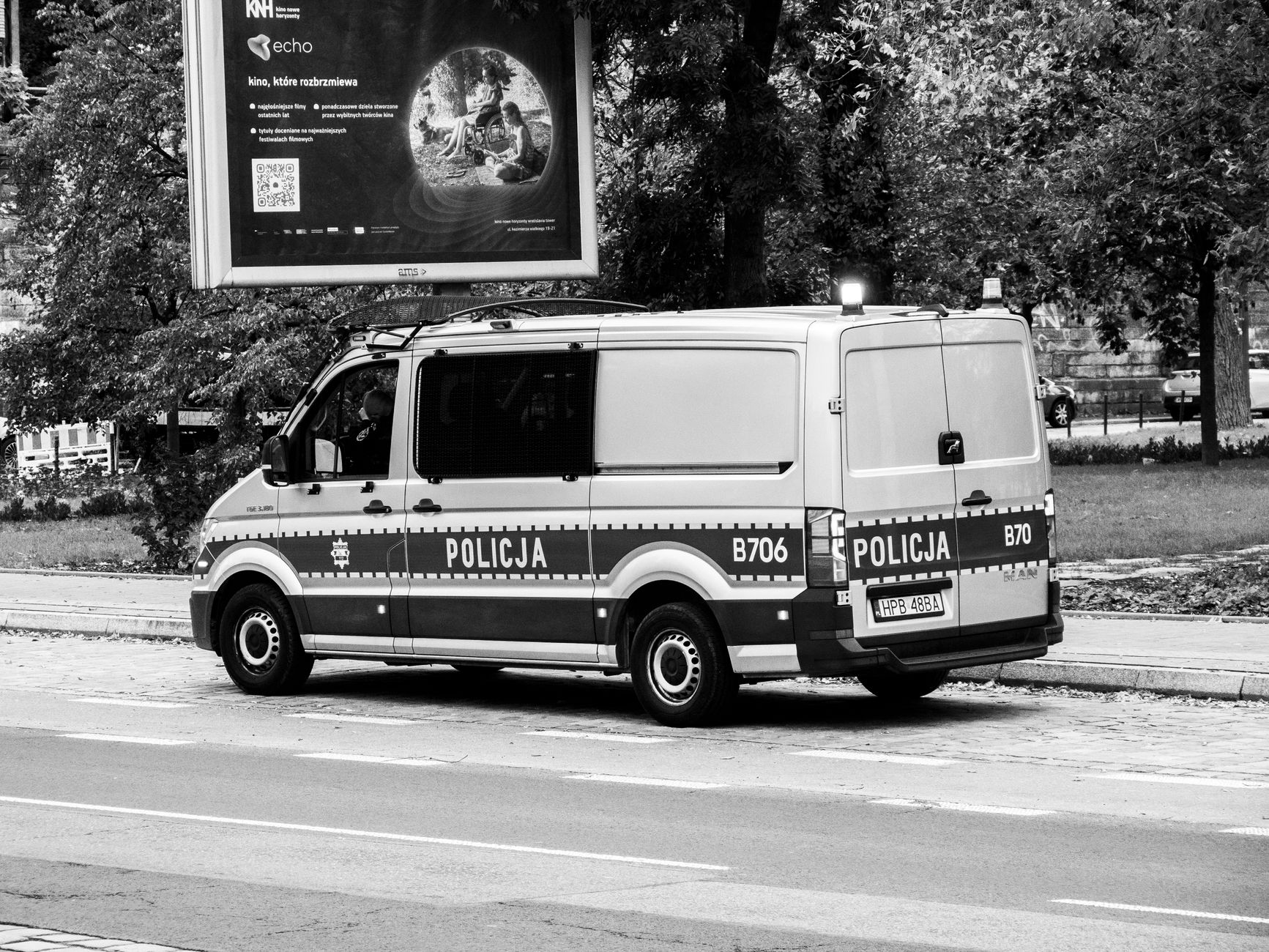 Service vehicle on a long rural highway, evoking windshield time and mileage charges on robot support visits.