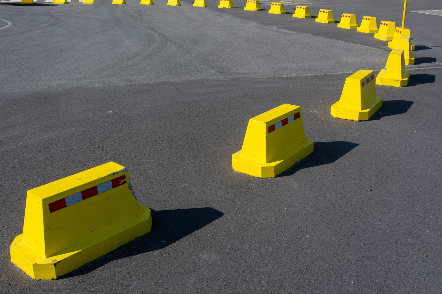 Industrial safety barriers enclose a designated area where controlled oily-part drop tests can be performed.