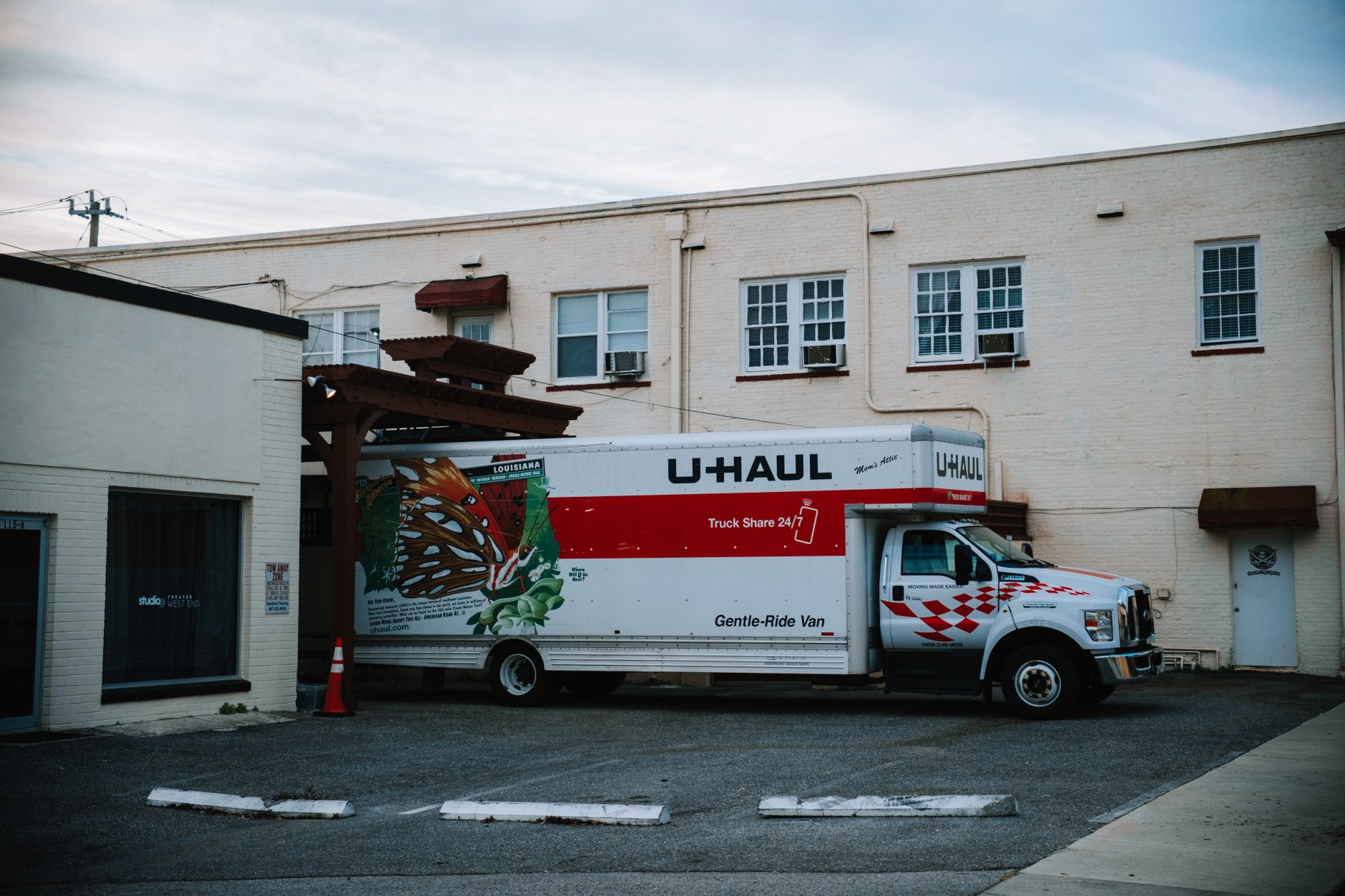 A freight truck at a loading bay, evoking the logistics of moving equipment between facilities.
