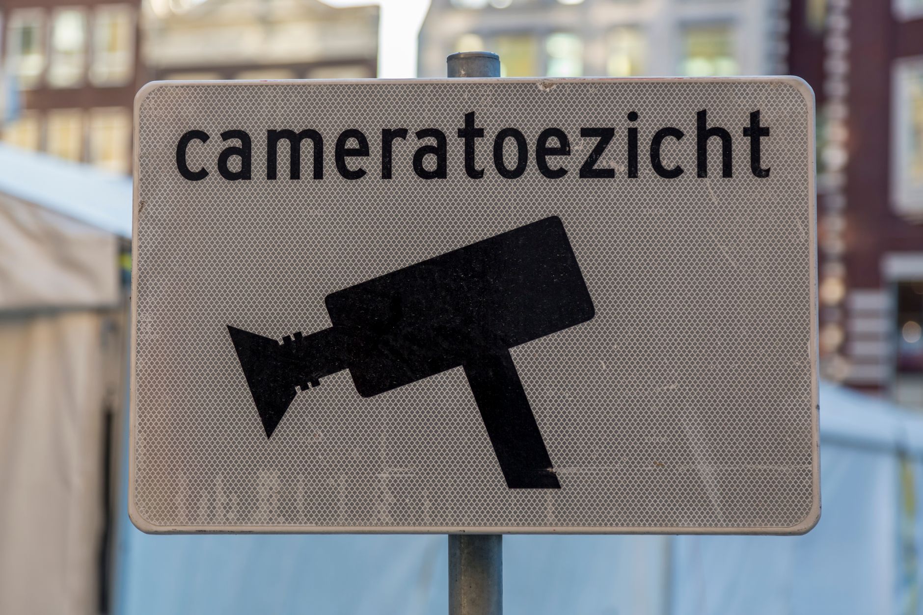 A posted video surveillance notice at a gated vehicle entry.