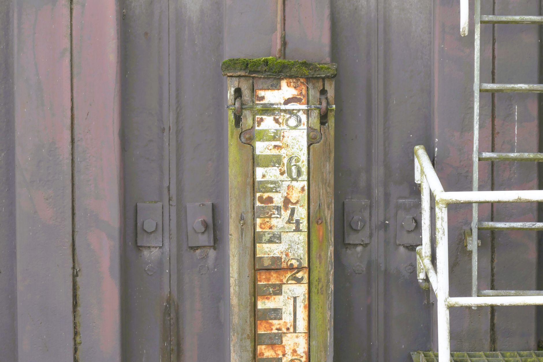 Close view of a loading dock leveler plate bridging the warehouse floor and trailer threshold.