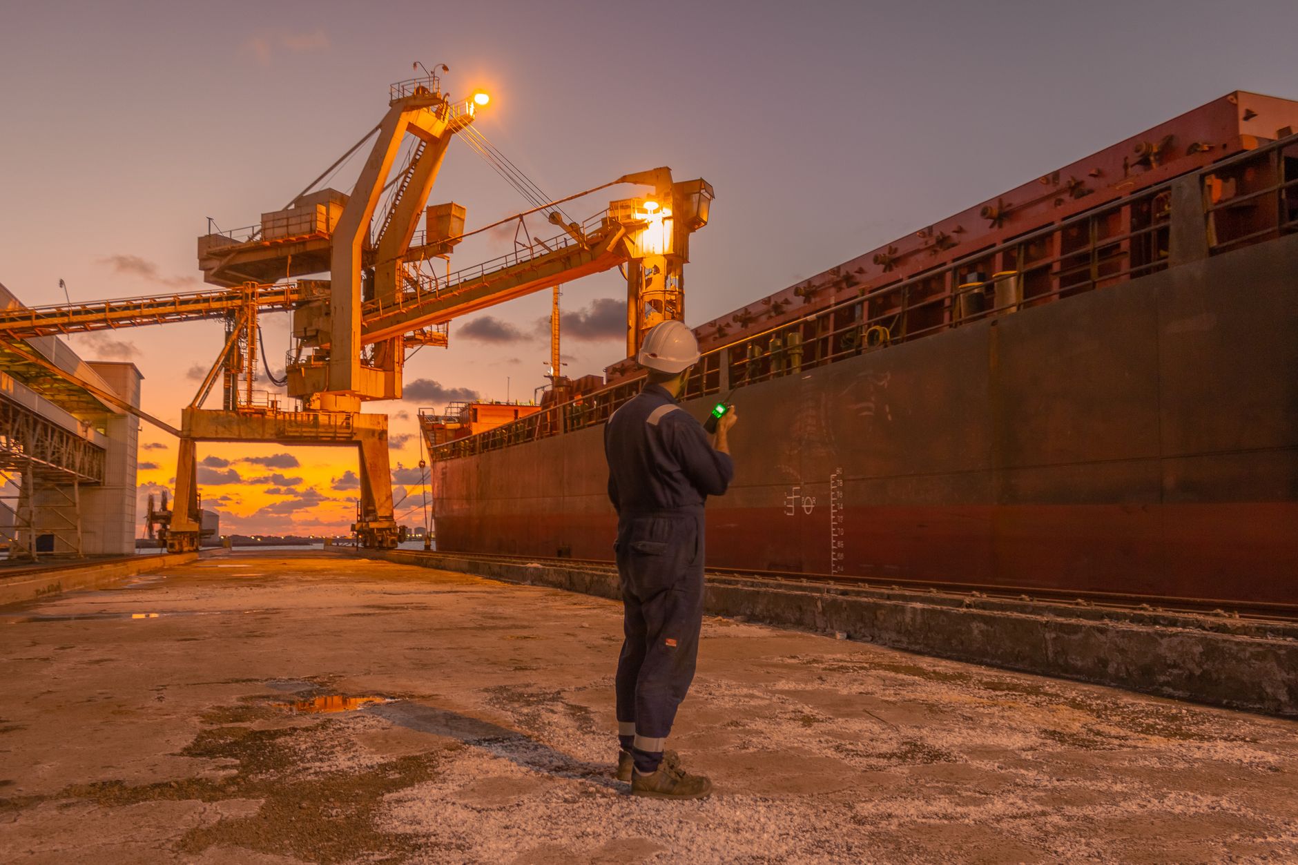A warehouse worker inspecting a loading dock area before shipping operations begin.