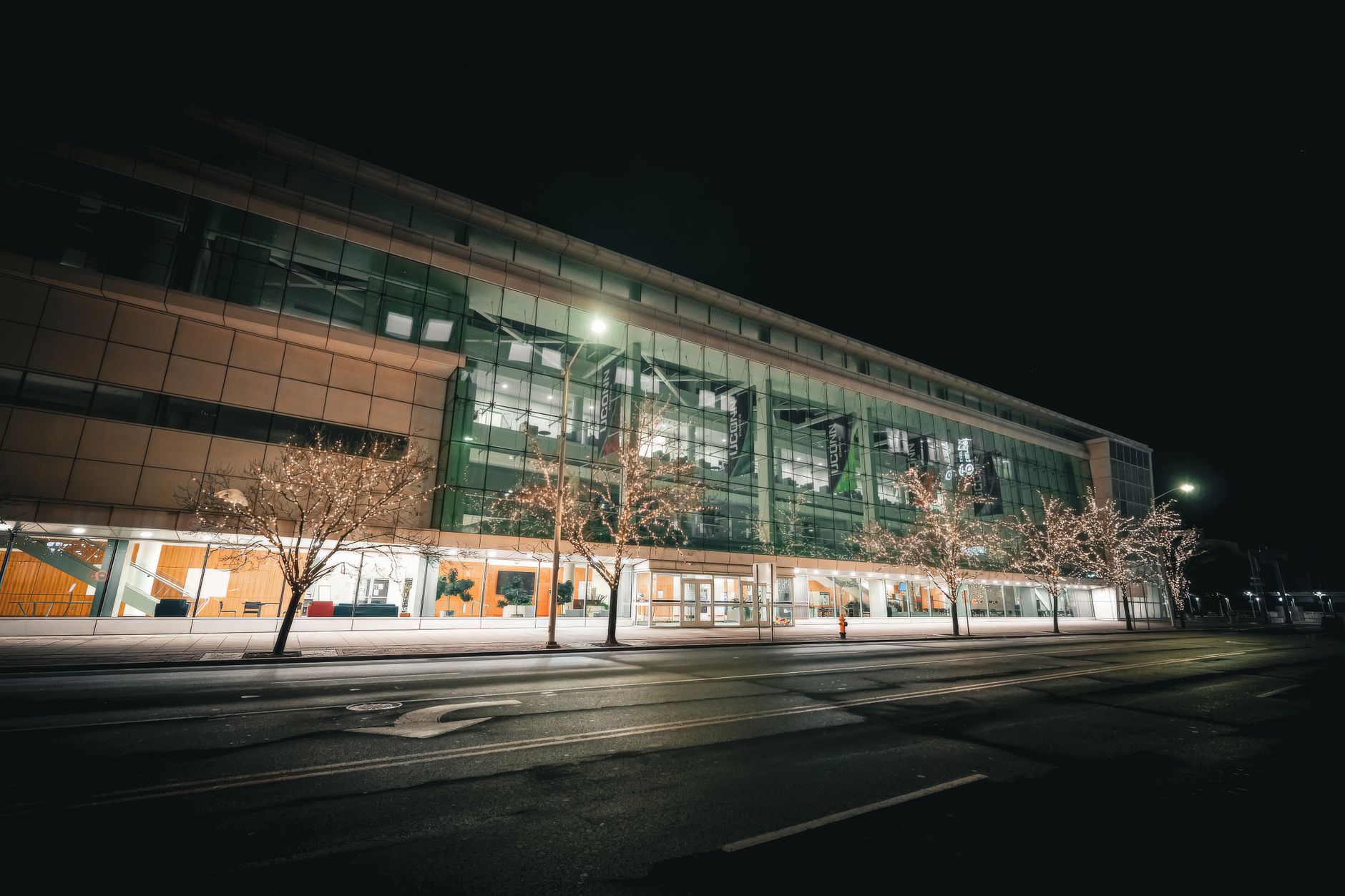 A night cleaner works in a quiet commercial corridor during an after-hours shift.
