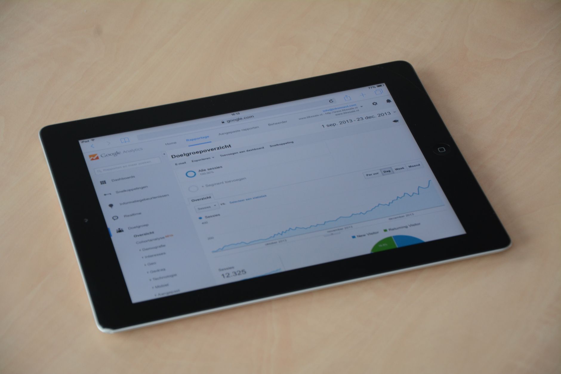 A person holding a tablet that displays data analytics and charts, showing how a robot command center provides data for fleet optimization.
