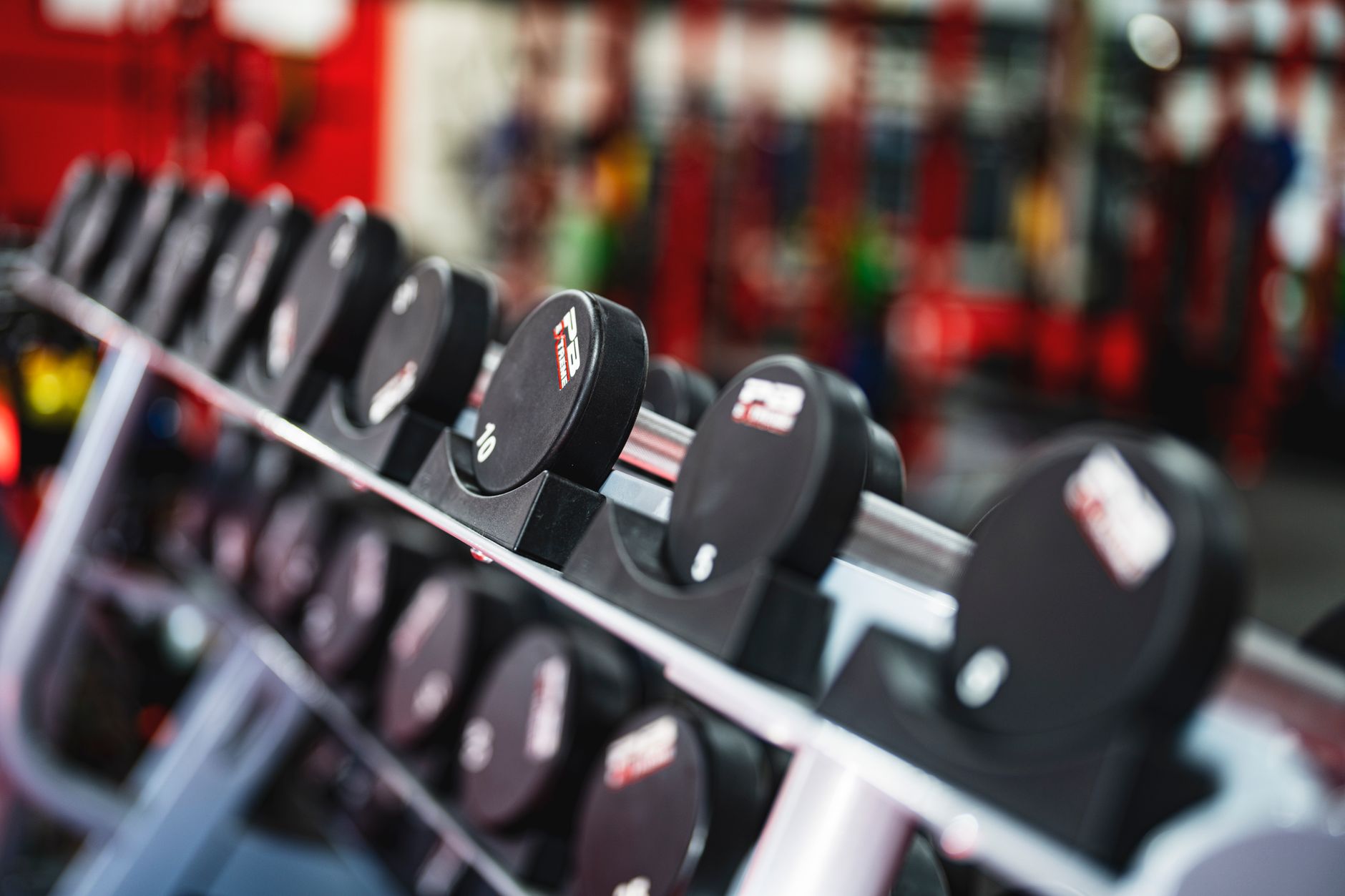 Free-weight area with racks, benches, and rubber flooring where debris, tight turns, and edge cleaning matter most.