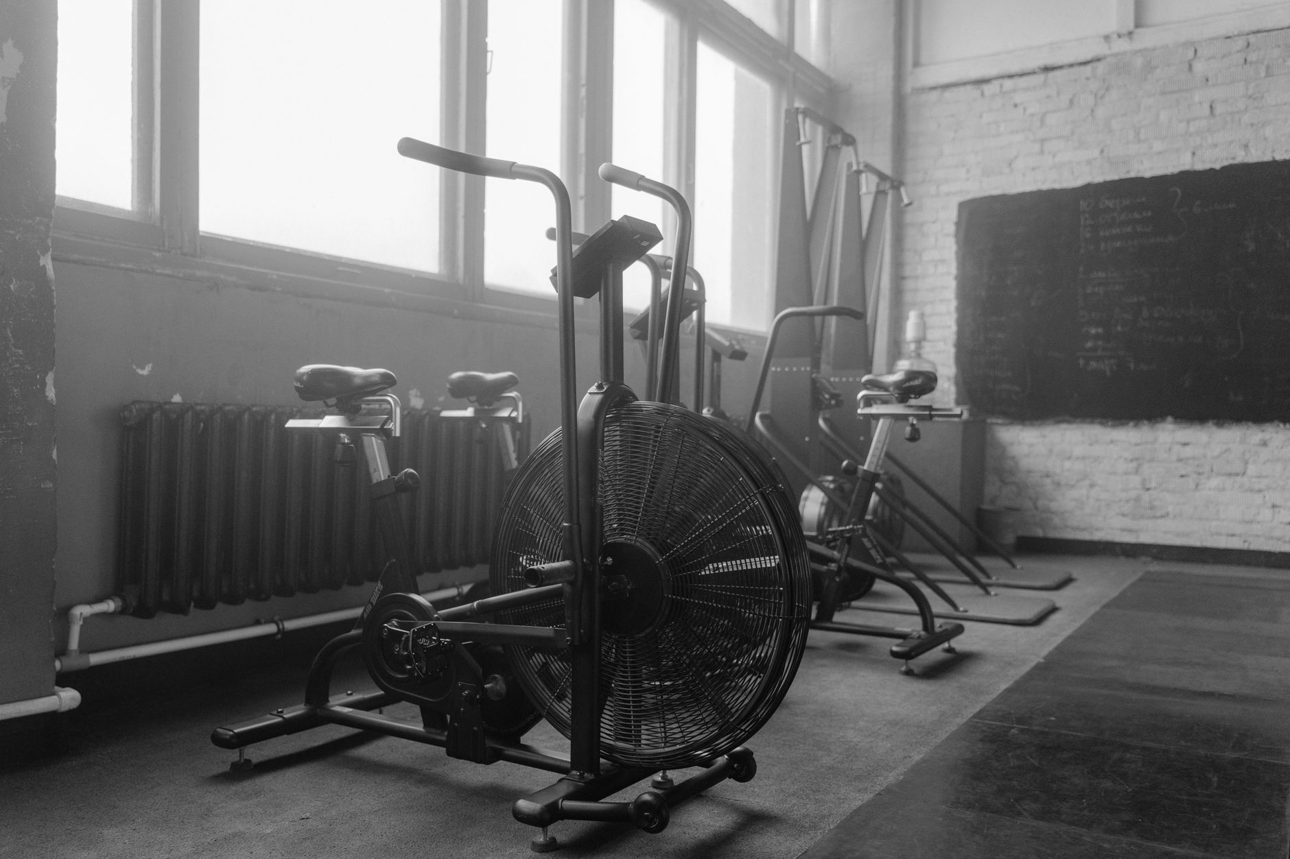 Wide view of an empty fitness center with rubber flooring, open workout zones, and clear overnight reset conditions.