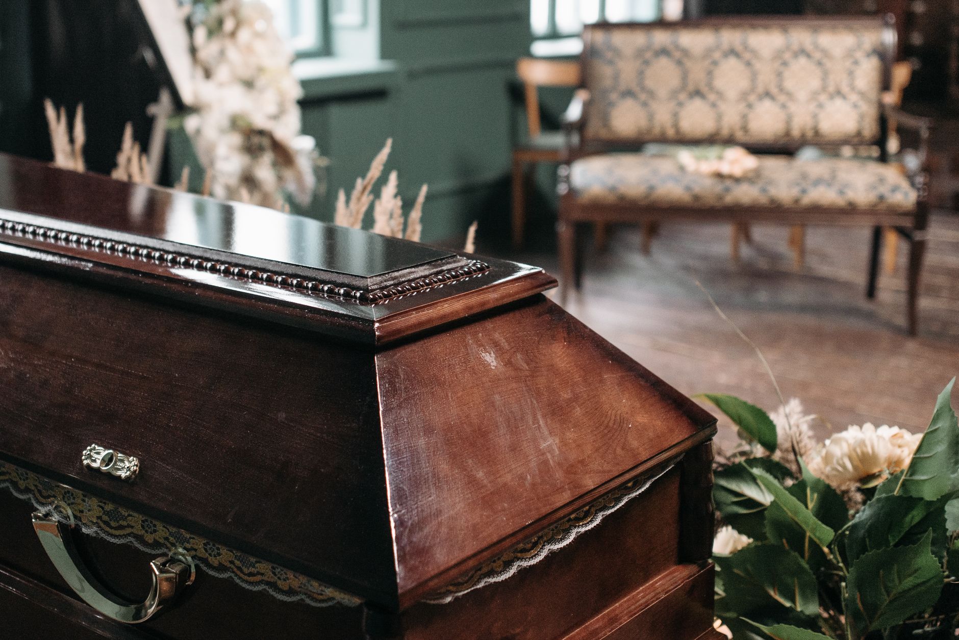 An empty funeral home chapel with rows of chairs, soft light, and polished floors that set a quiet, formal tone.