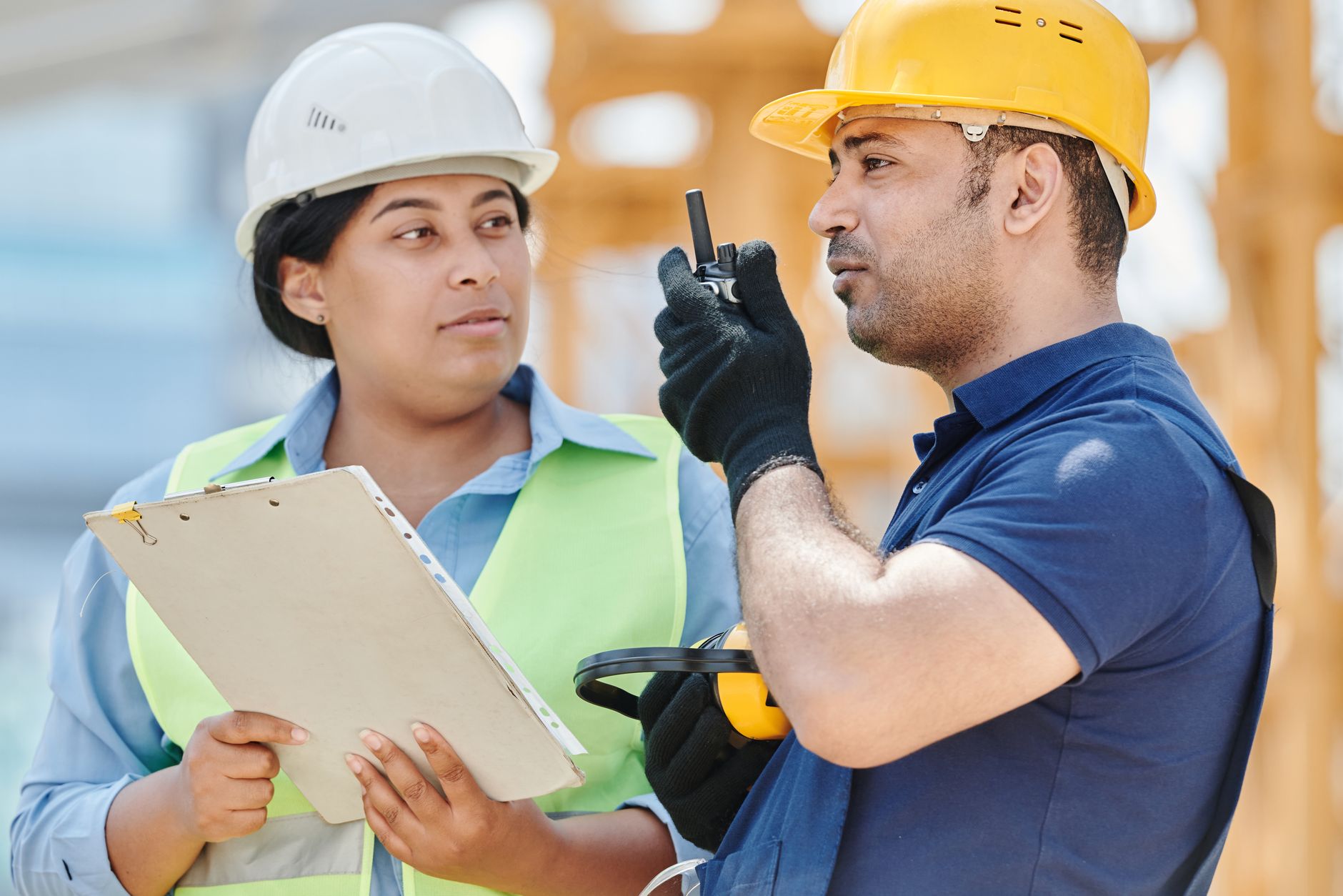 A warehouse worker uses a handheld radio during a manual fallback procedure.