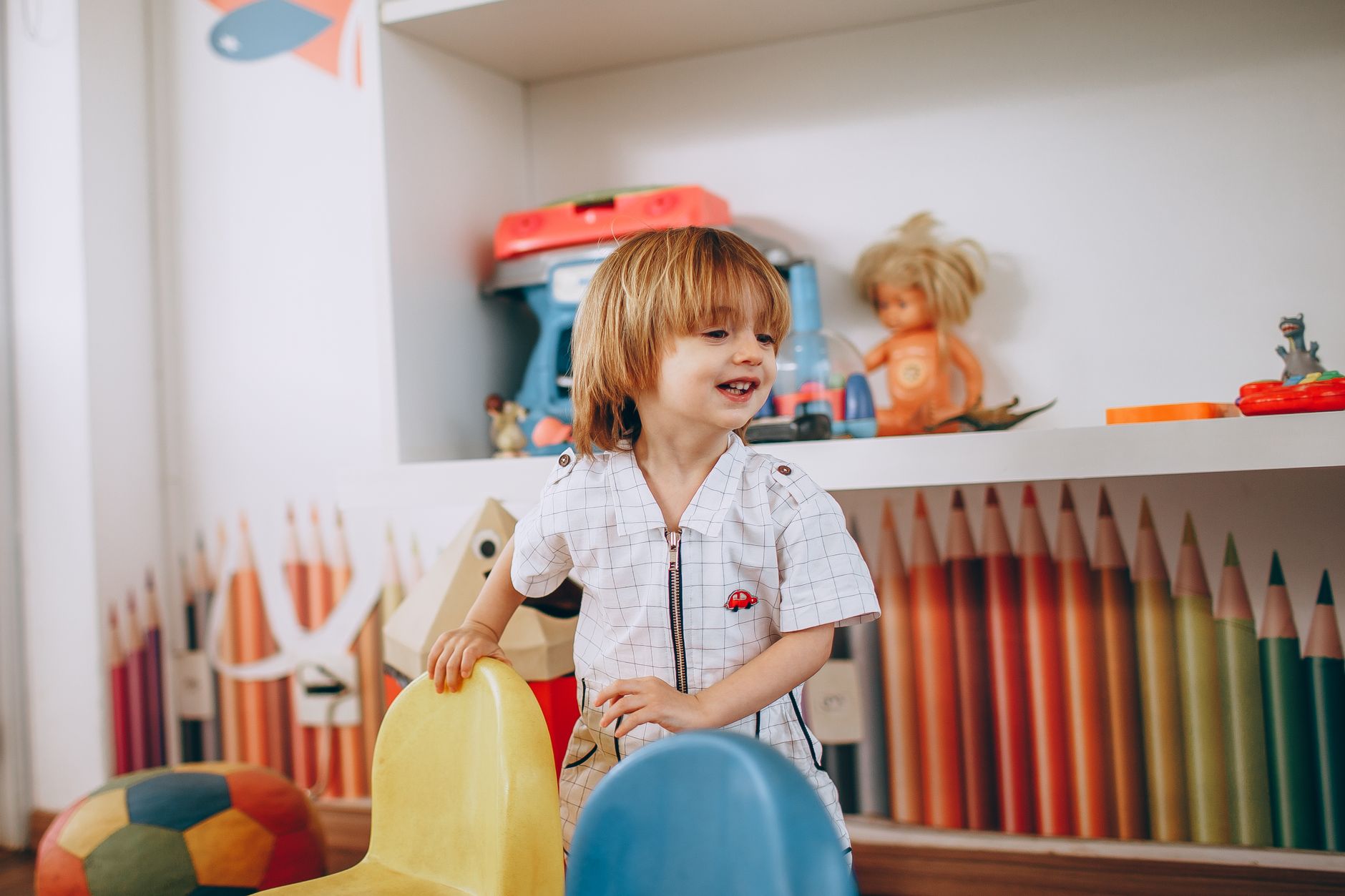 An orderly preschool classroom with low tables, cubbies, and soft-surface areas, showing why child-contact spaces need a different cleaning sequence from standard hallways.