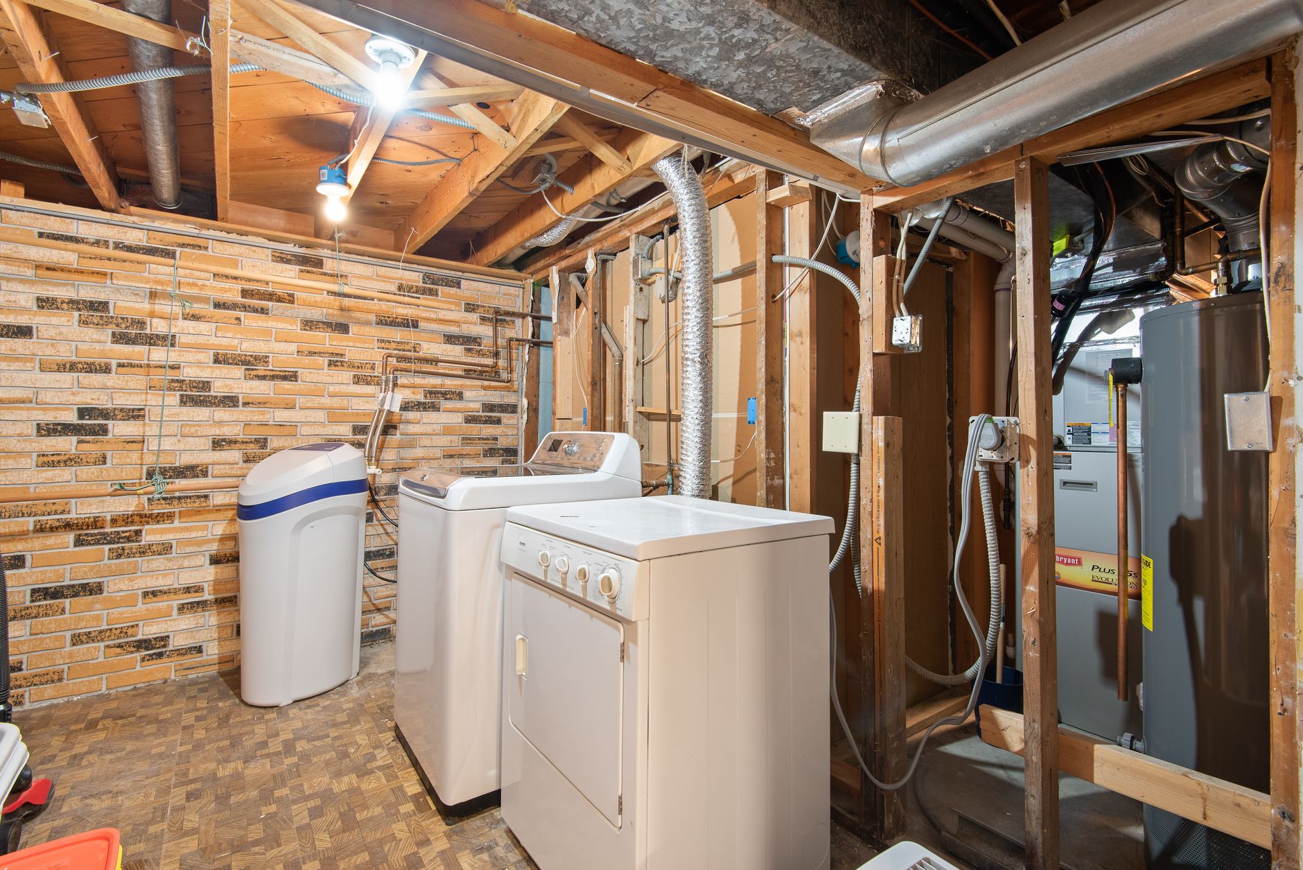 Exposed water service piping and valves in a basement utility space where backflow devices are often enclosed.