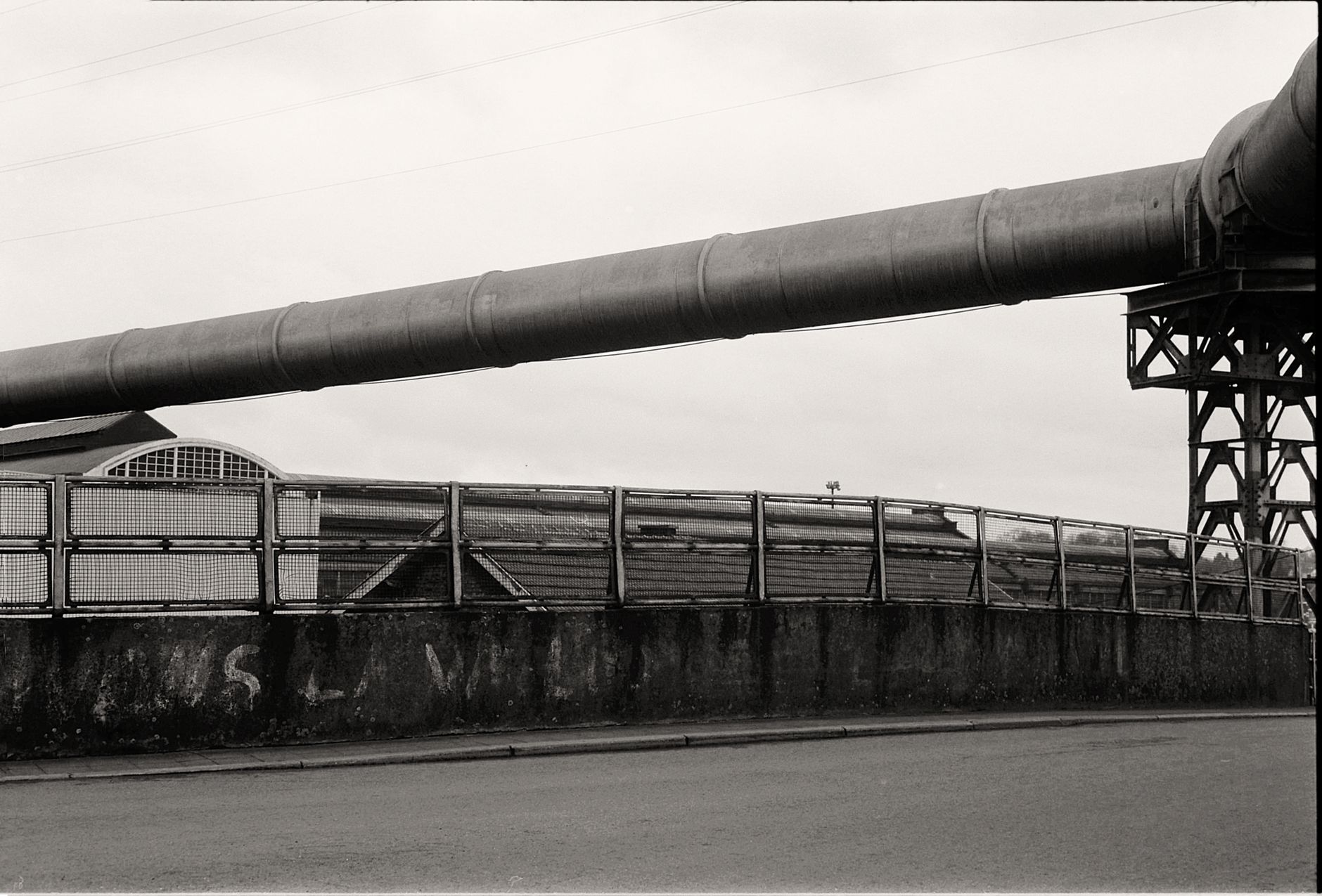 Elevated industrial piping and utility runs connecting production areas, similar to the spread-out routes brewery inspections must cover.