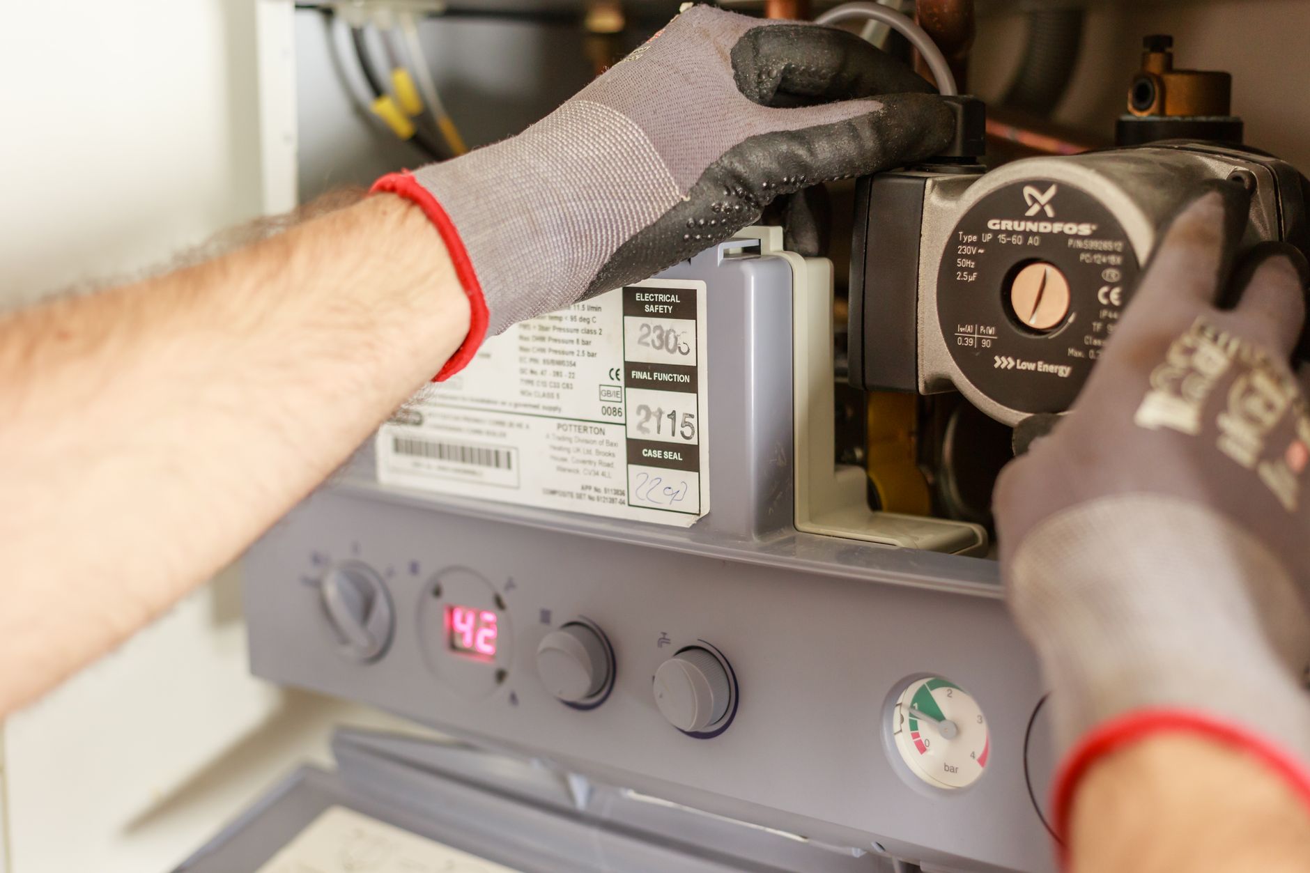 A qualified maintenance technician inspecting industrial pumps and associated equipment.