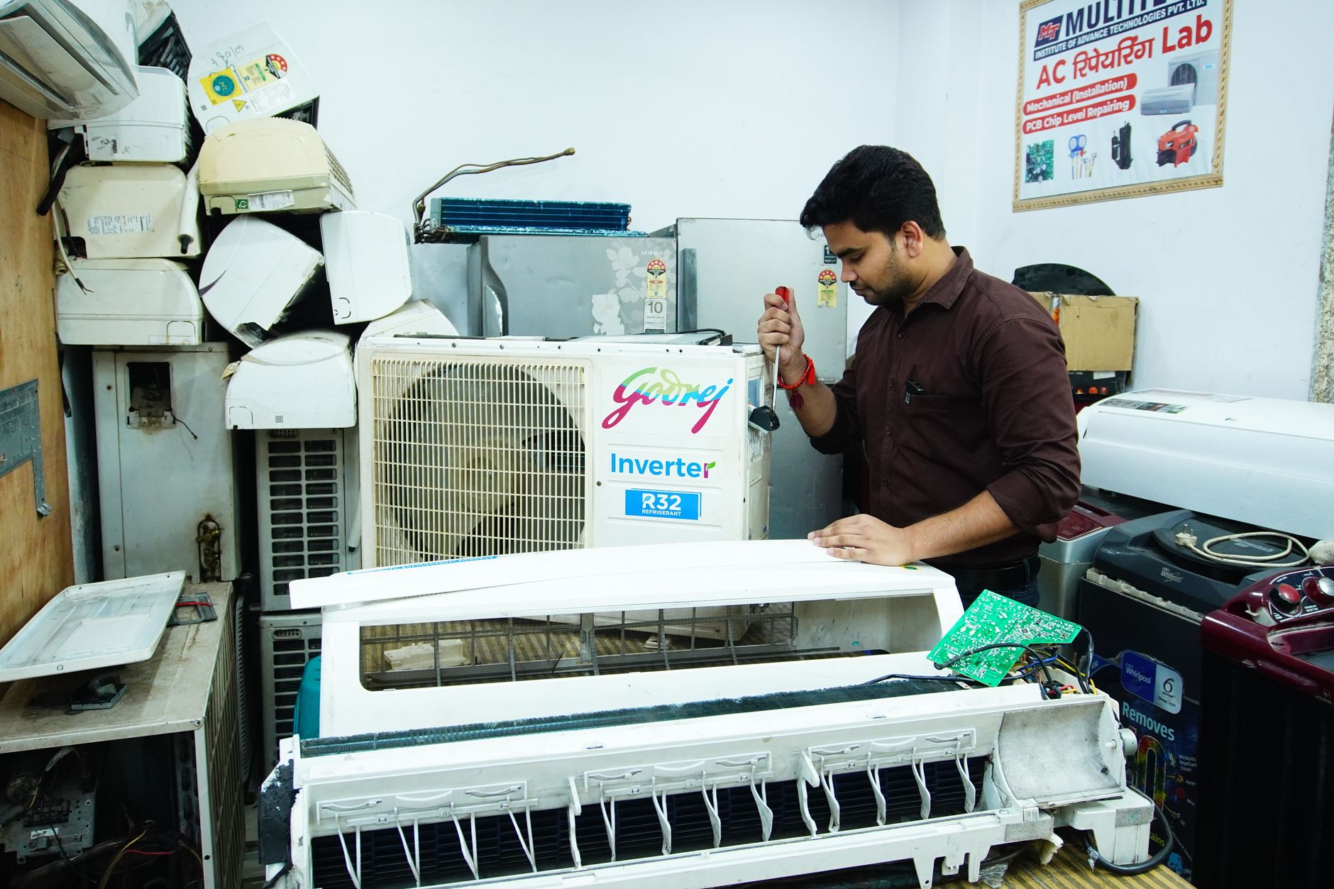 A qualified technician inspects piping and equipment inside an industrial mechanical room.