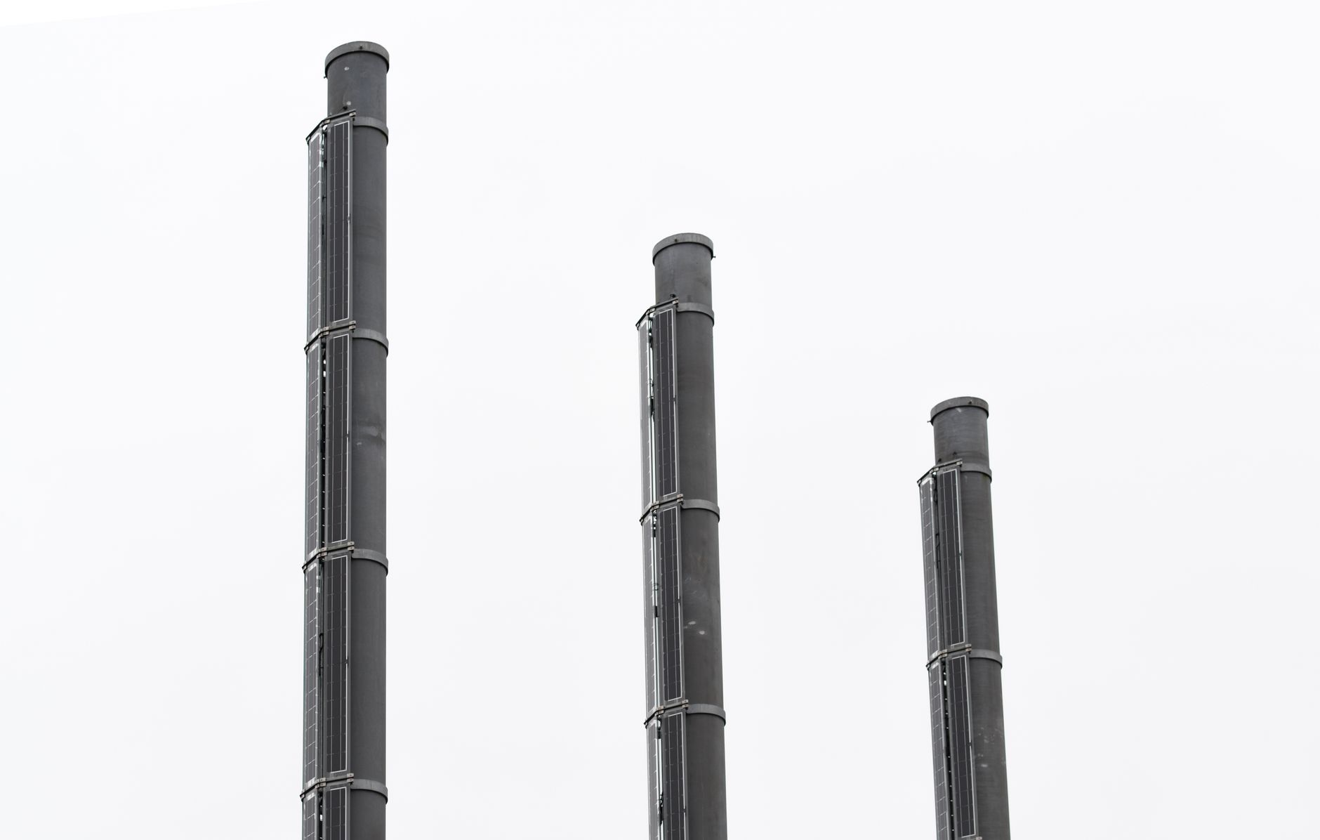 Overhead compressed-air piping in a manufacturing plant where ultrasonic leak surveys focus.
