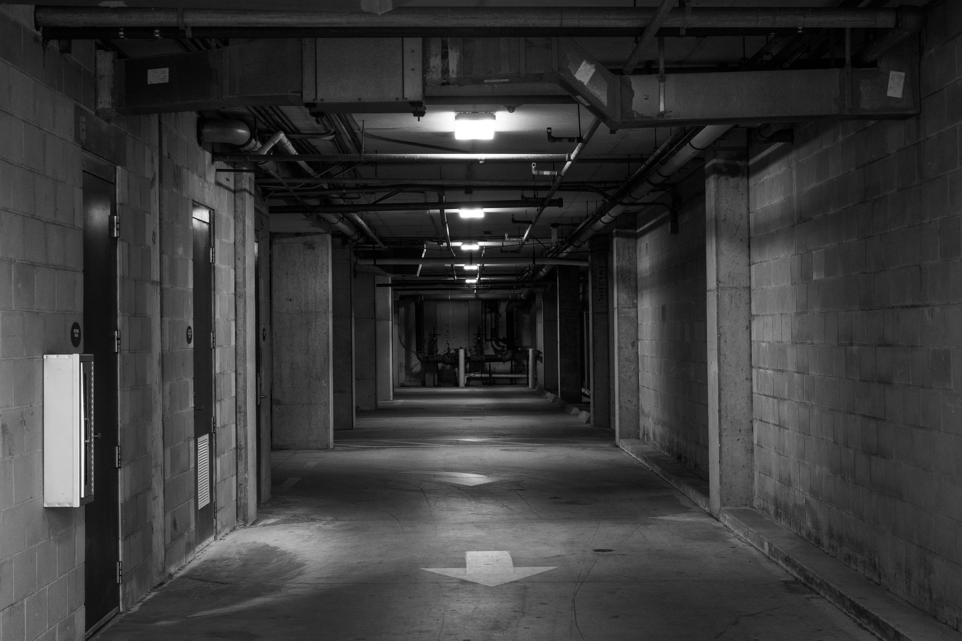 Long concrete service passage where radio signals fade without tested mesh or edge recording.