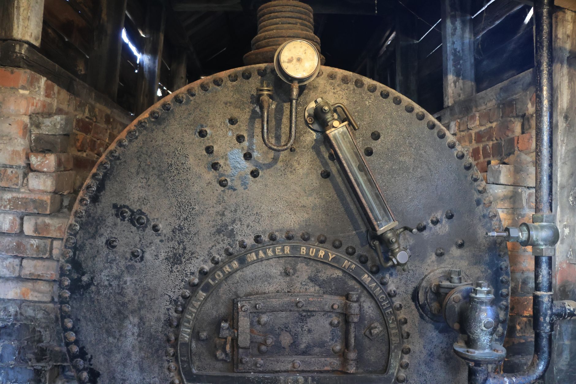 Pressure gauges and valves on a hydronic boiler header that repeat photo angles must capture consistently.