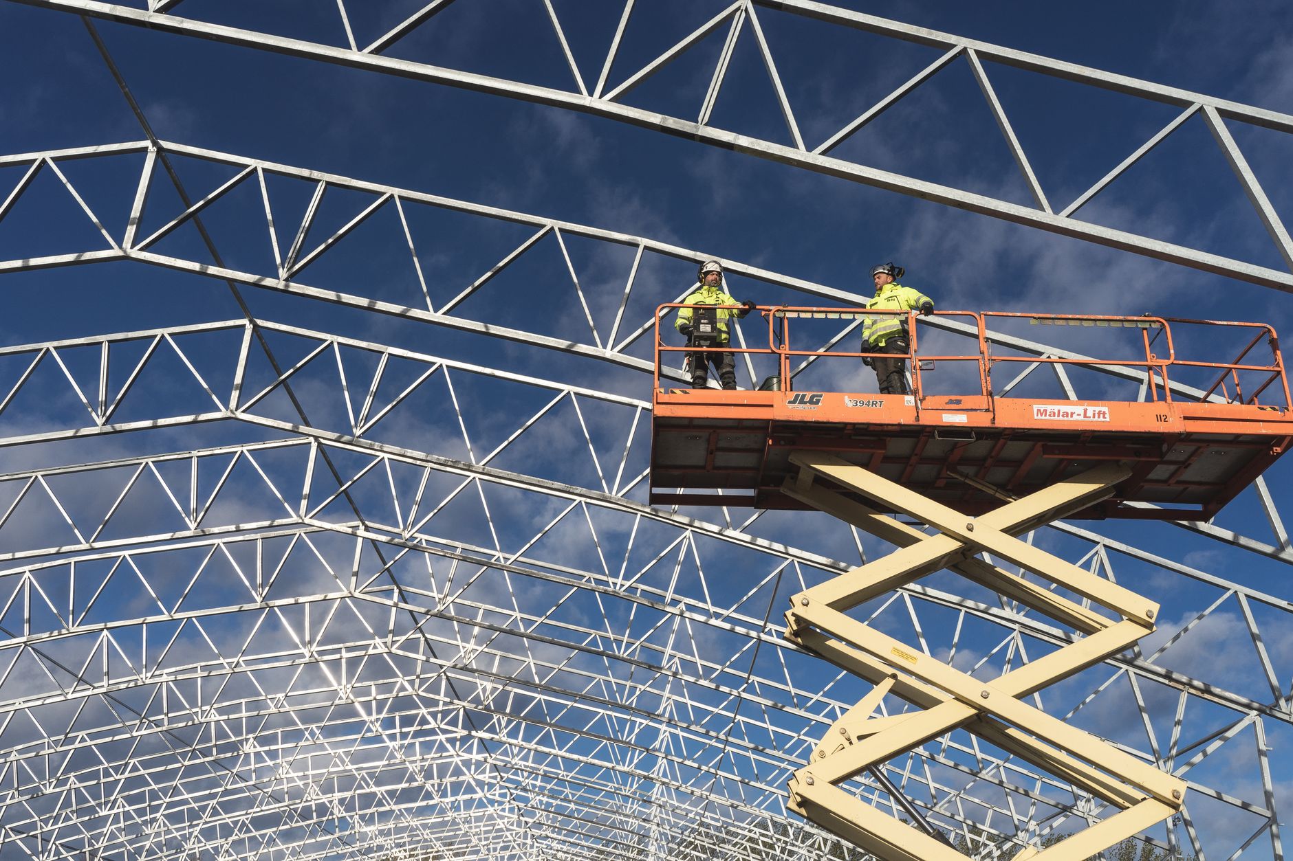 Elevated work platform positioned near tall industrial equipment where manlifts consume outage time.
