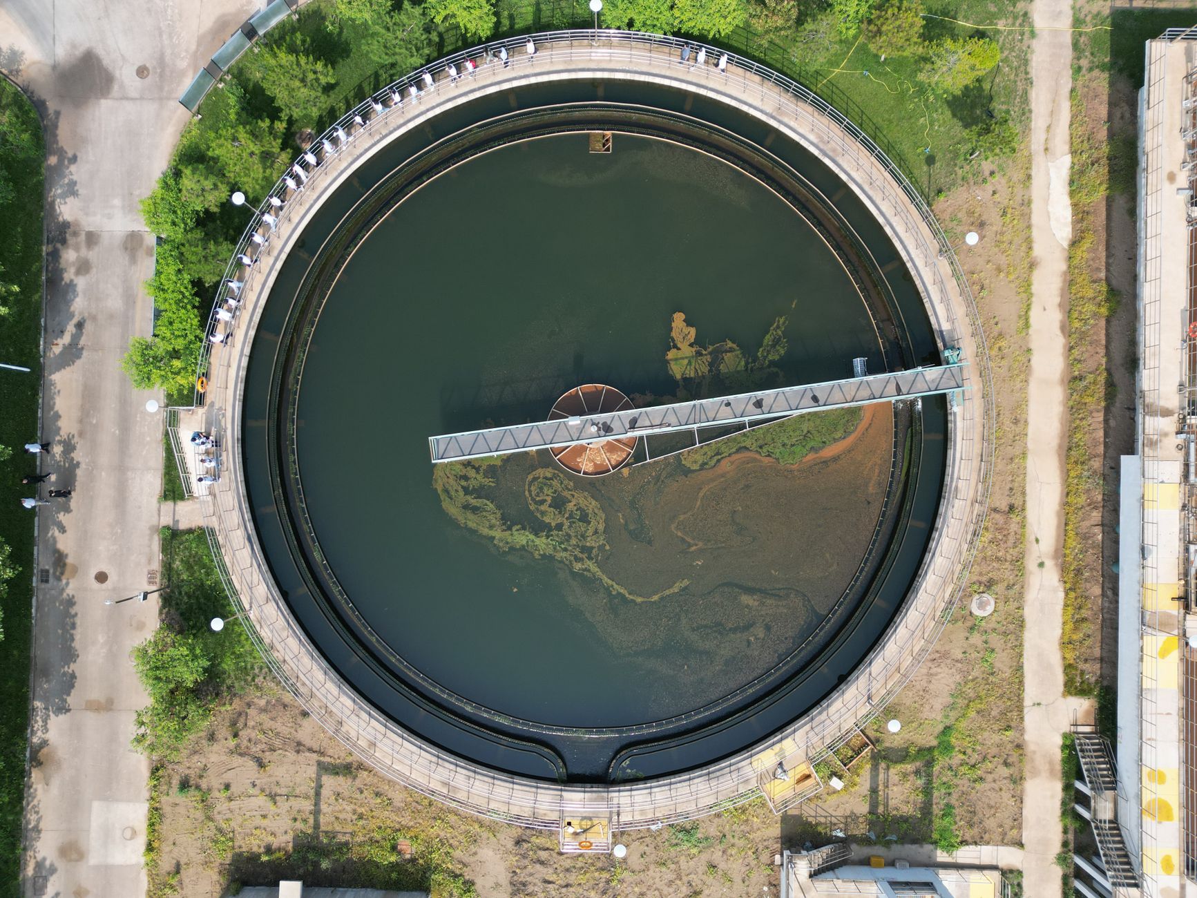 The vast and complex interior of a municipal water treatment plant, with large basins and pipes requiring regular inspection.