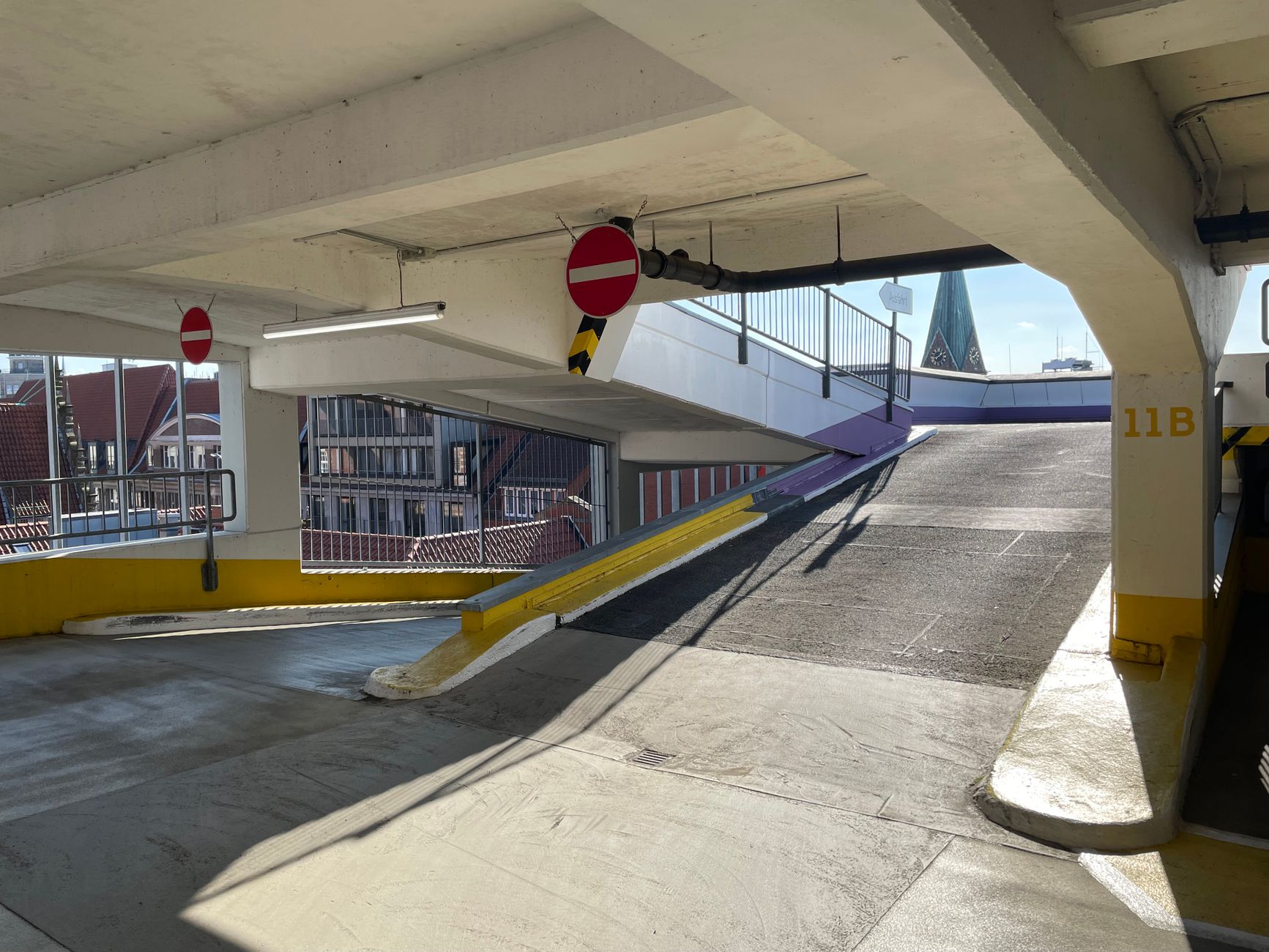 Parking ramp transition where mixed daylight and fixture glare change how joint sealant appears on camera.