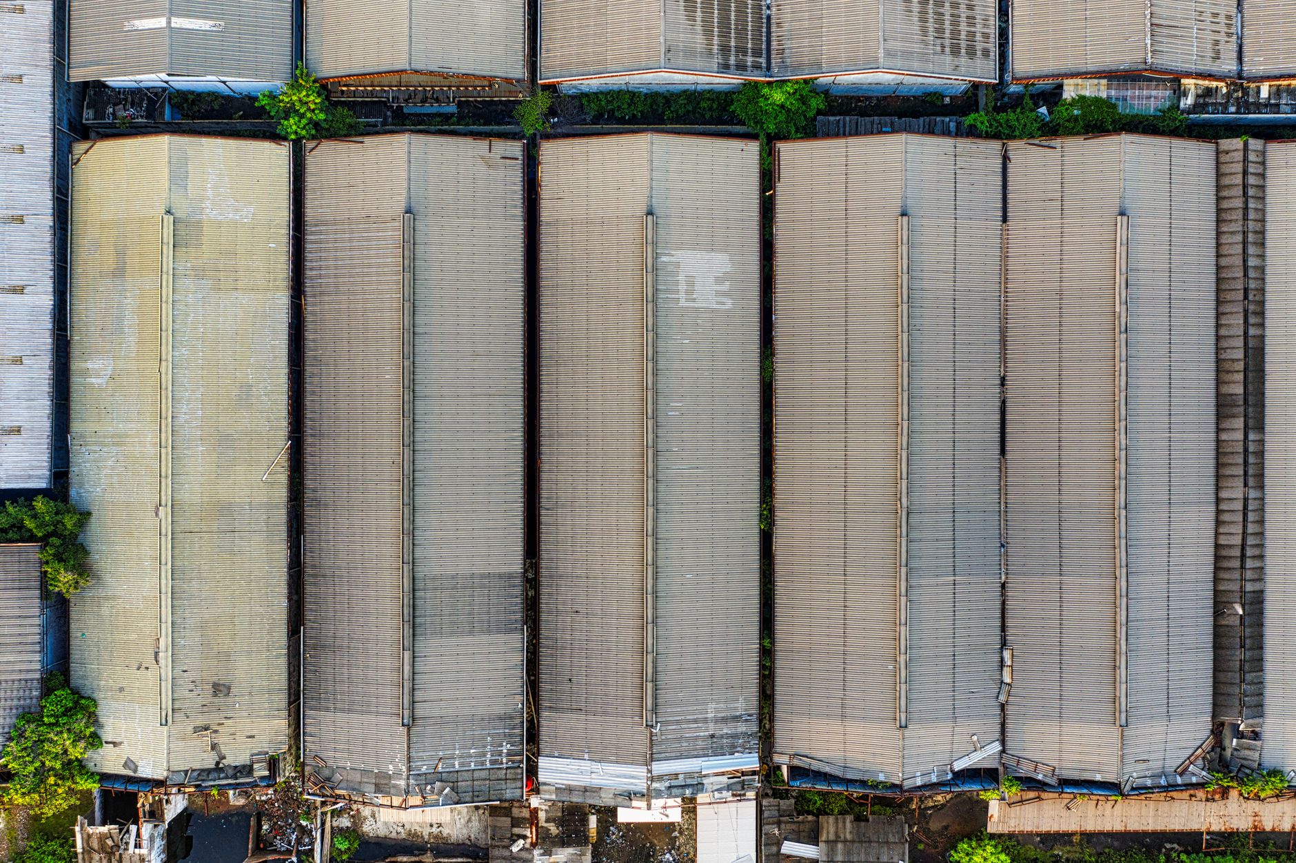 High, wide view of a large industrial or commercial rooftop that shows how many drains and obstacles can be spread across one inspection route.