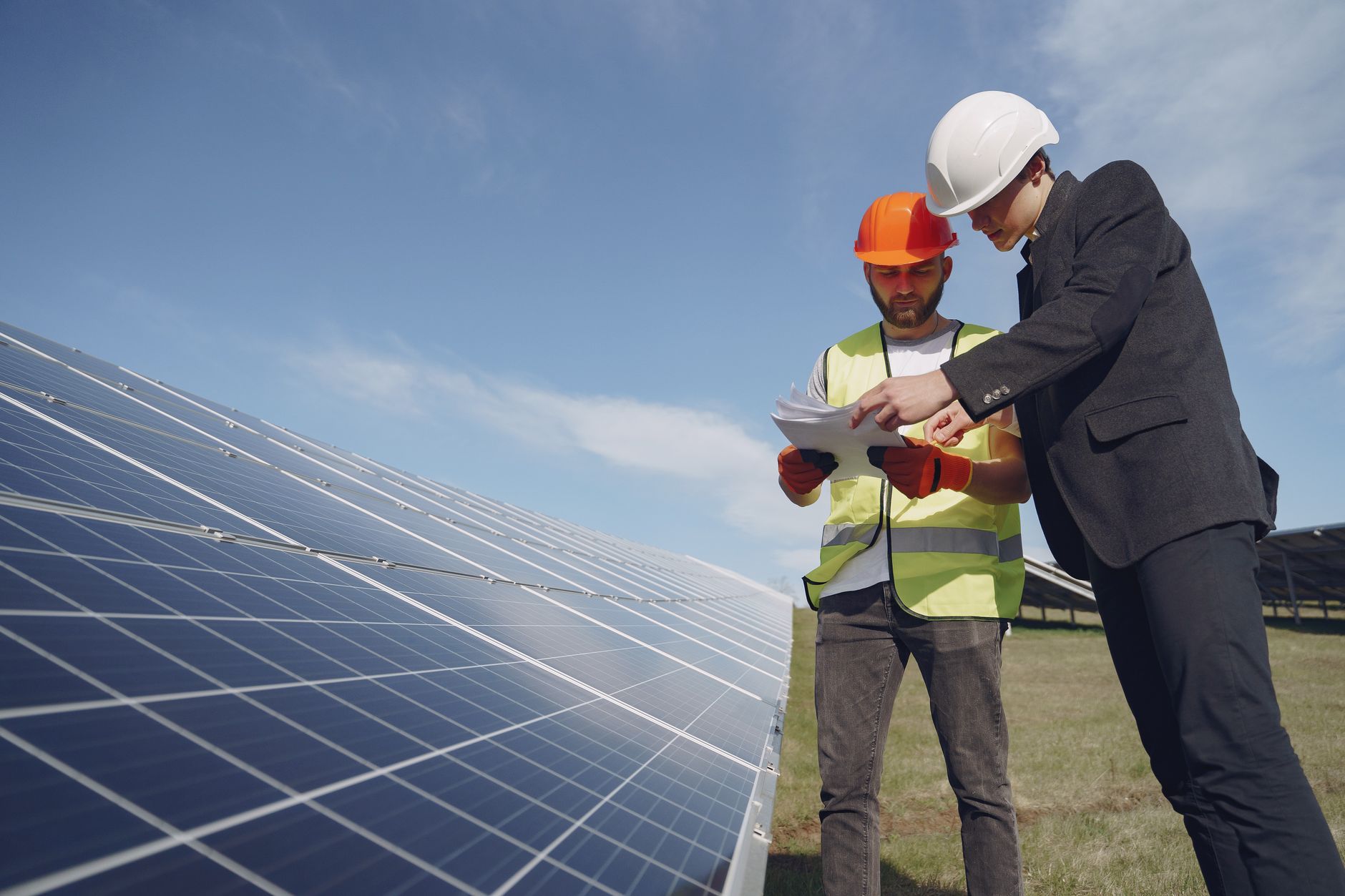 A technician checks solar equipment in the field, reinforcing that robots support targeted maintenance rather than replace skilled crews.