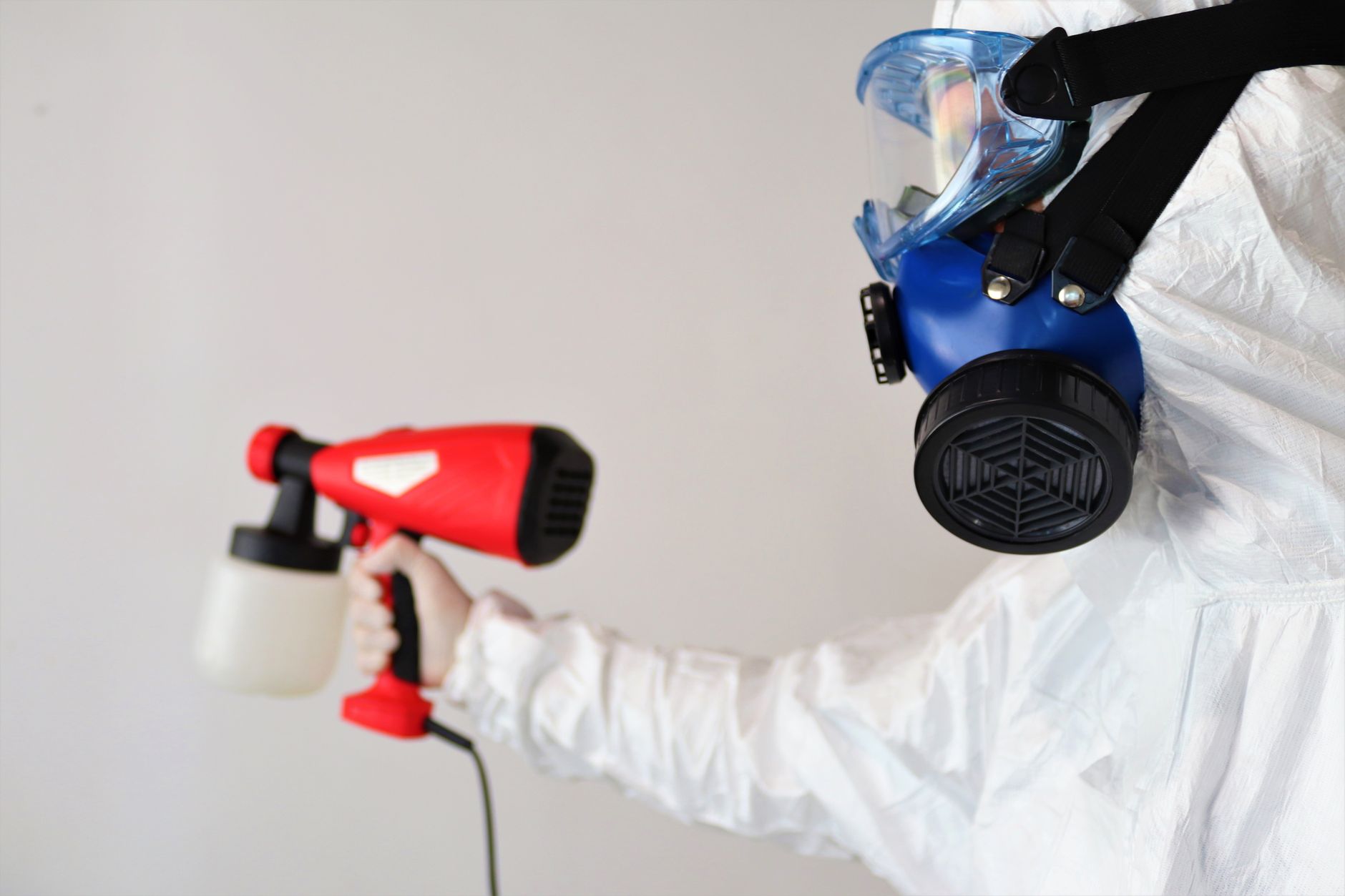 A janitorial staff member carefully disinfects a high-touch countertop, illustrating a detailed task better suited for humans.