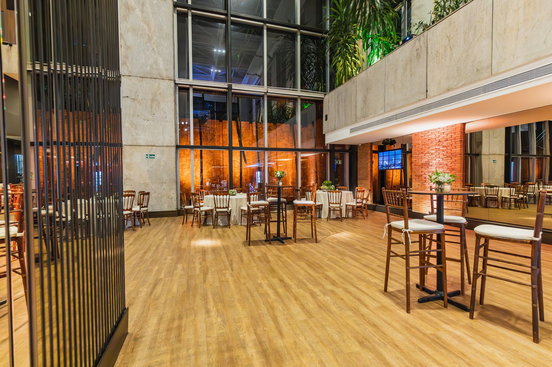 A large hotel conference hall with a complex layout of round tables and chairs, illustrating the challenging environment for cleaning.