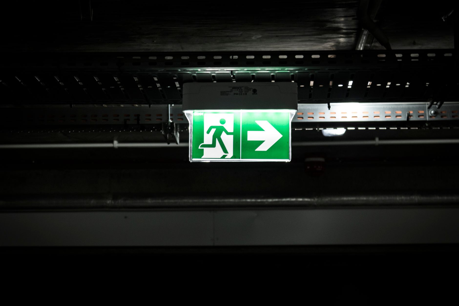 An exit corridor where robots must clear accessible routes quickly during an alarm.
