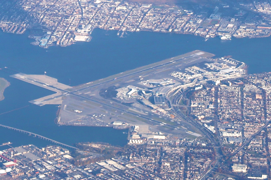 LaGuardia Airport terminal exterior and roadway approach, setting the scene for a high-traffic public terminal where robotics operations are highly visible.