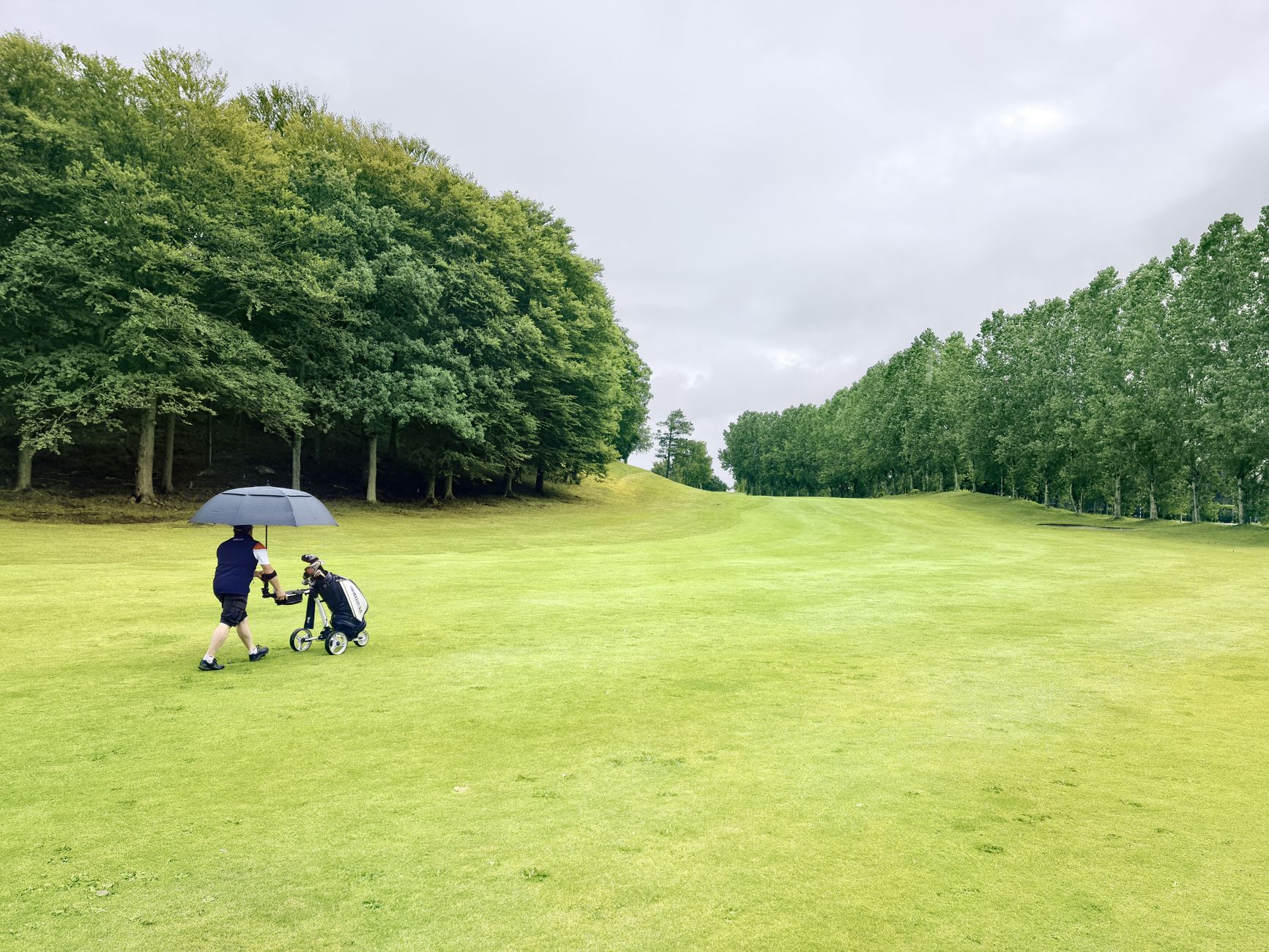 Golfers waiting out rain under shelter