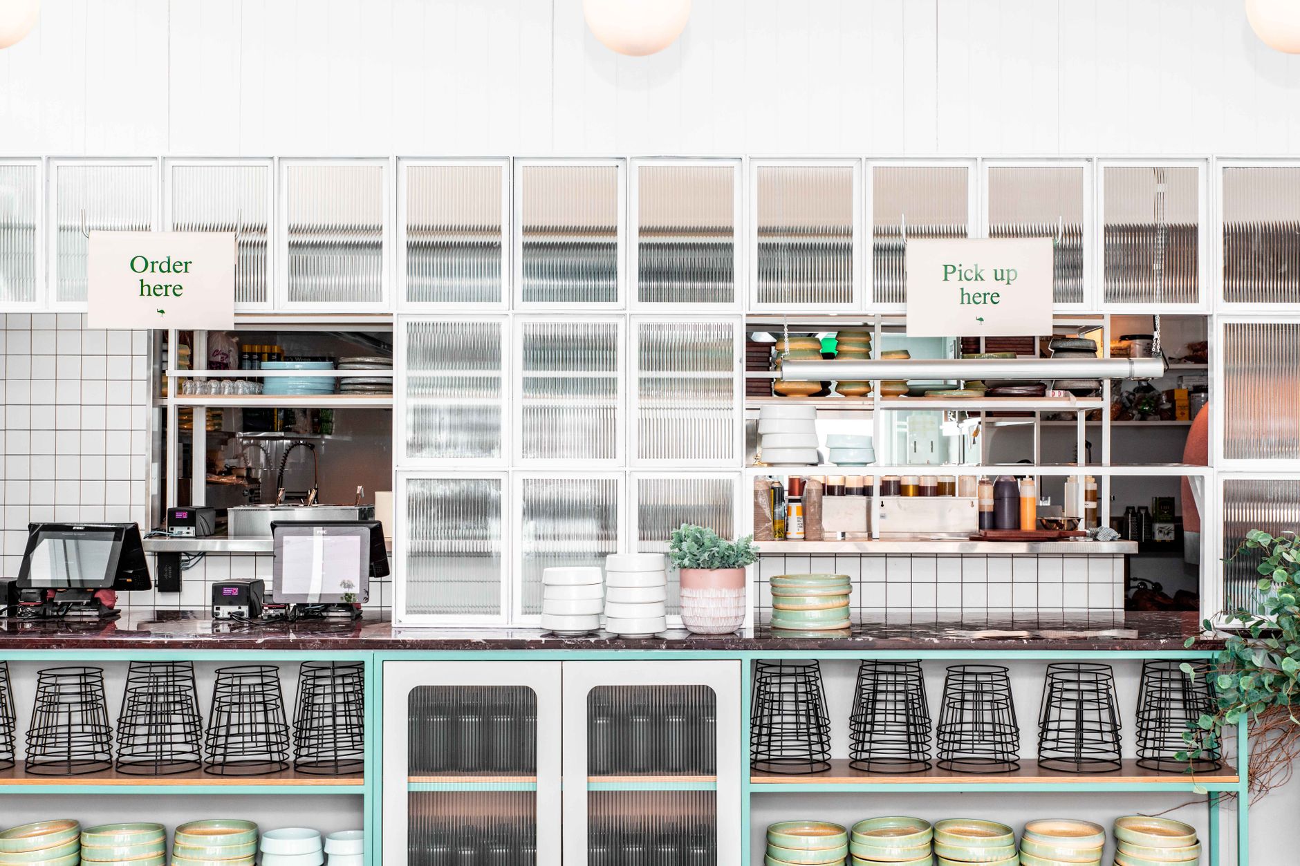 Prepared takeout orders lined up on a restaurant pickup shelf, highlighting the operational importance of marketplace and dispatch integration.