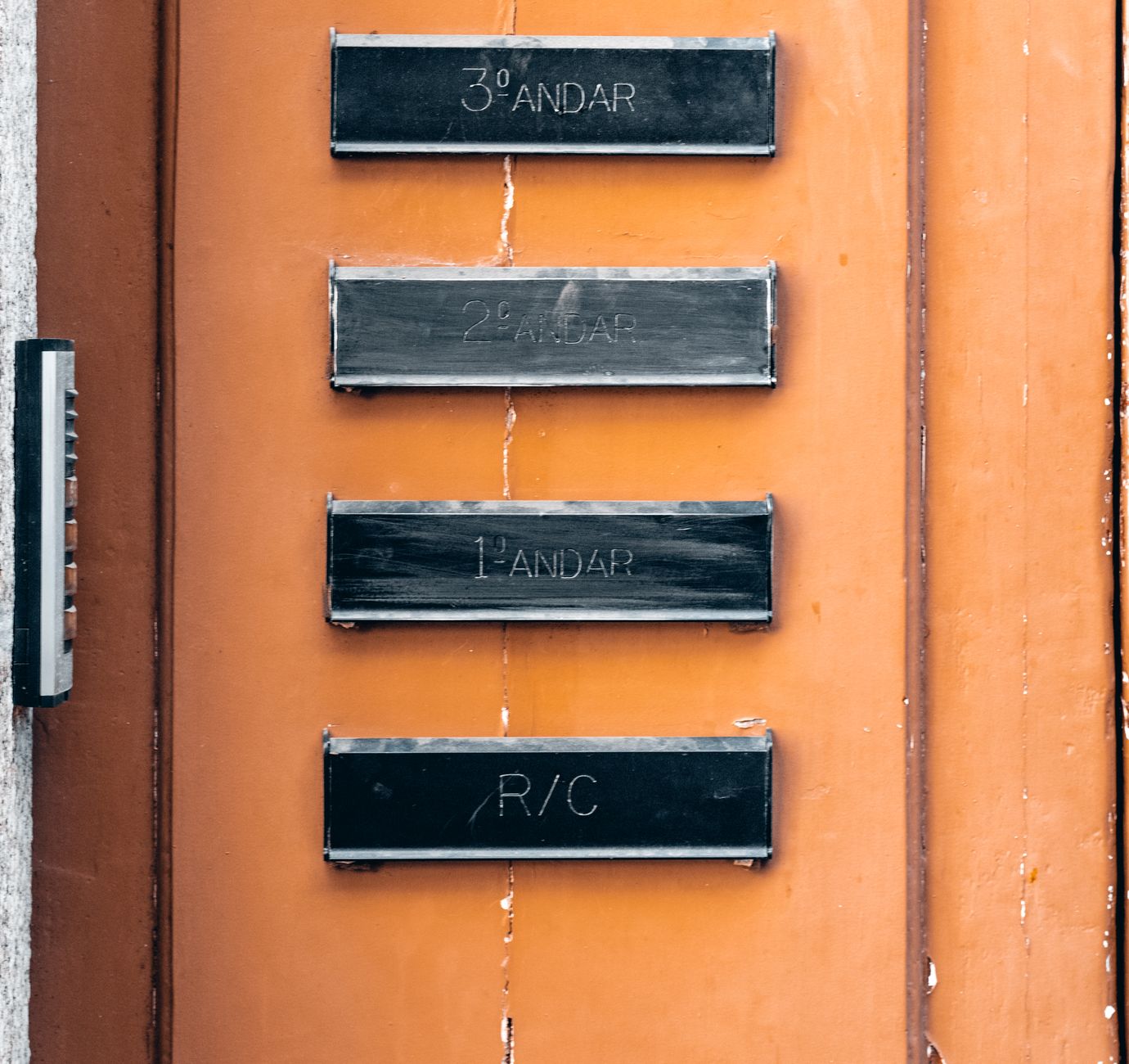 Entrance to a multi-unit apartment building in a city, representing the handoff and access challenges that can still limit delivery operations.