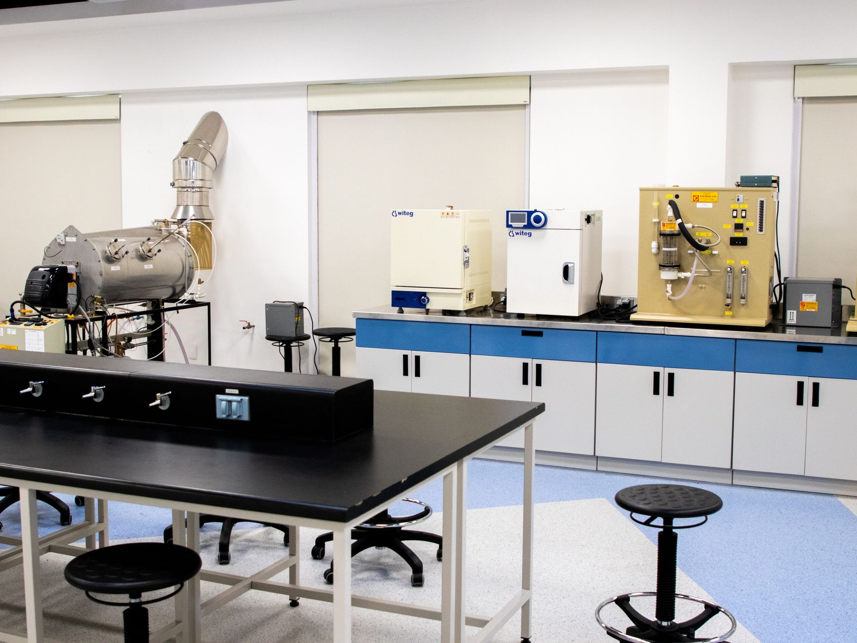 Close-up of gleaming stainless steel surfaces in a sterile facility, representing the non-particulating materials used in cleanroom equipment.