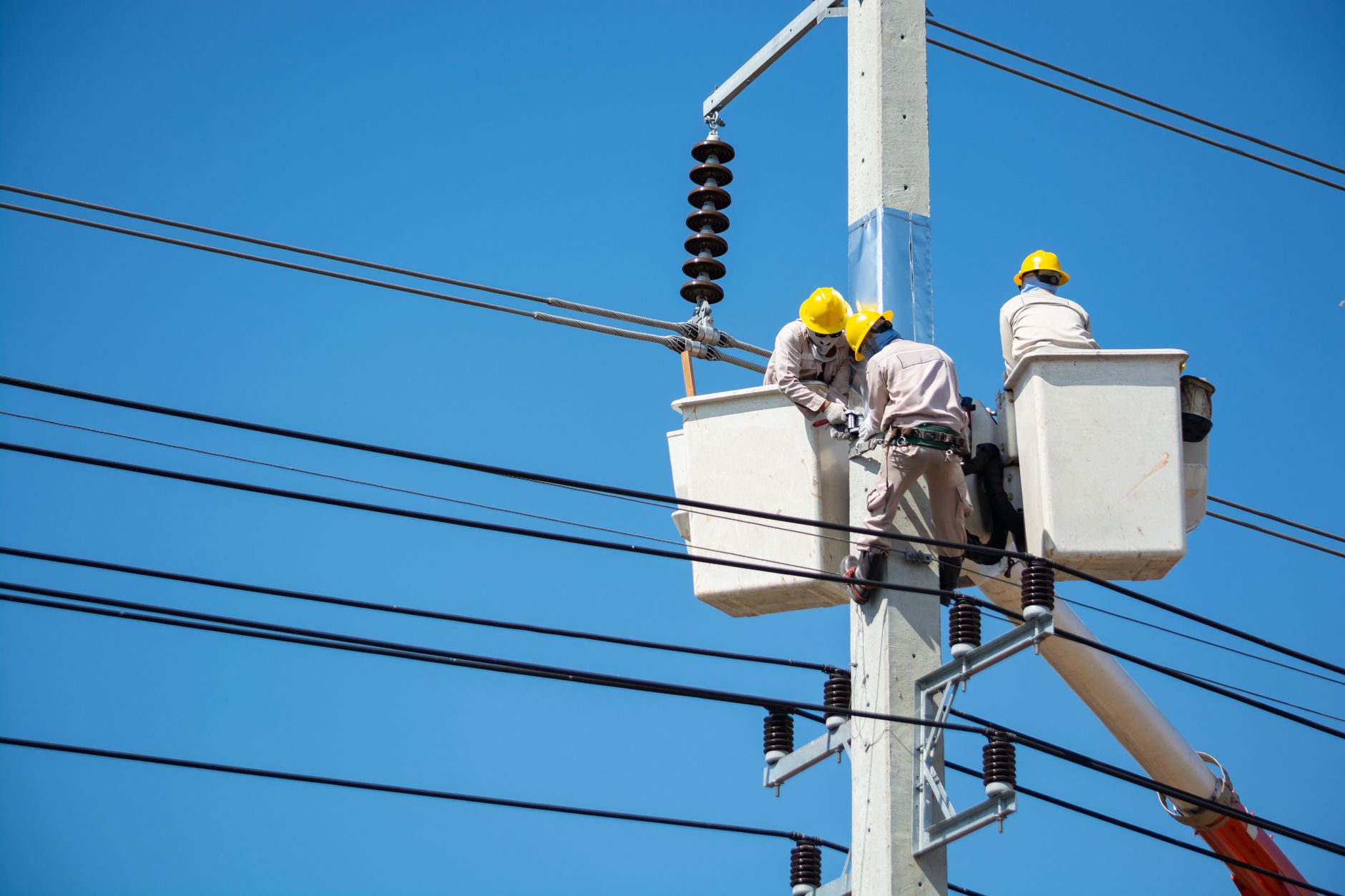 A technician inspects electrical equipment during an after-hours facility round.