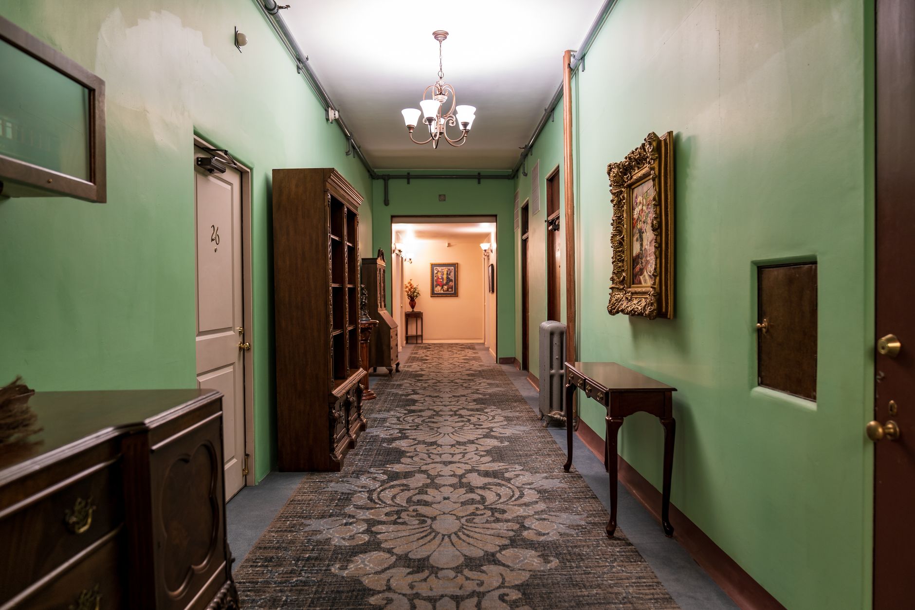 A quiet, well-lit corridor in a Marriott hotel, leading to guest rooms where delivery robots provide prompt service.