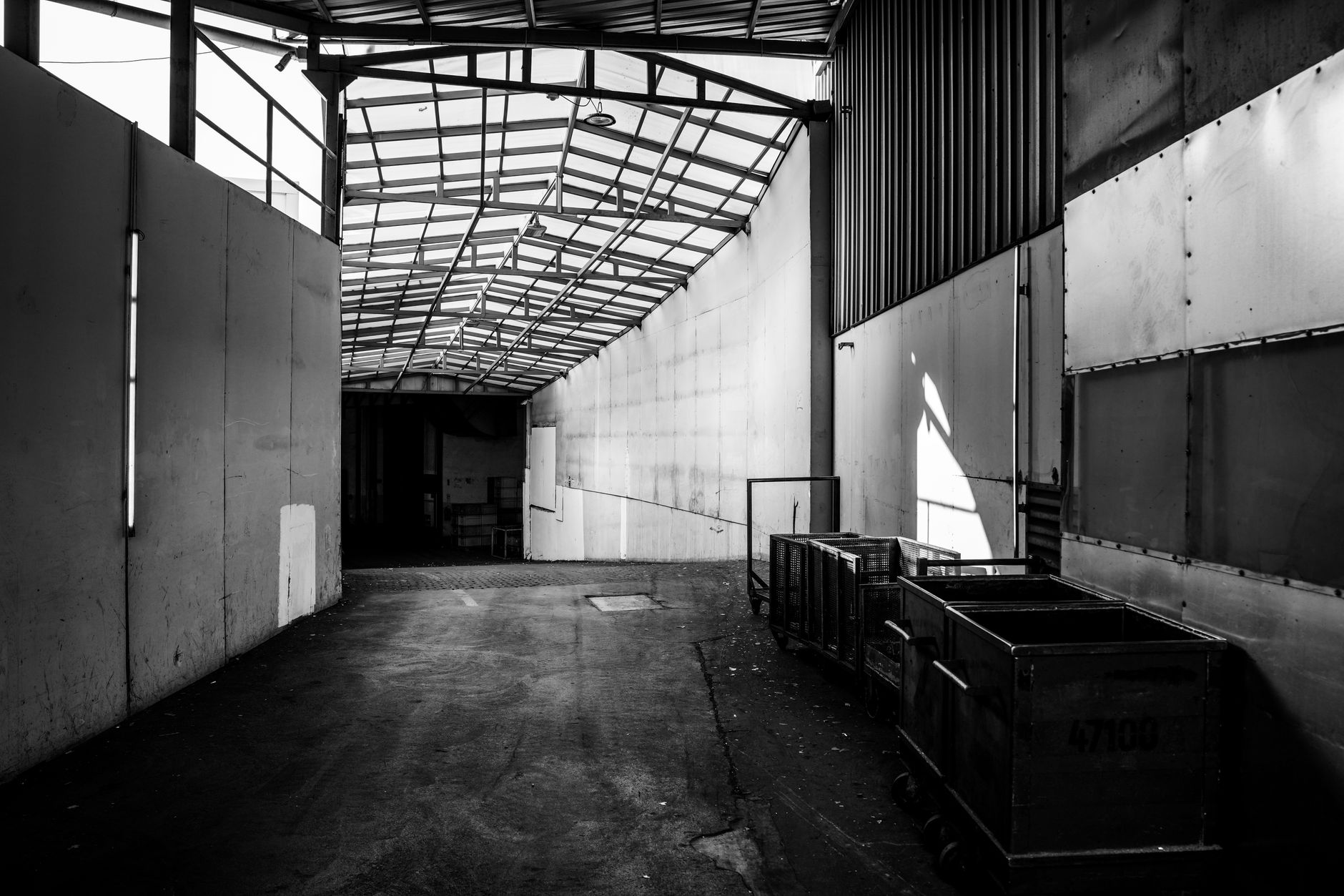A cart in a factory corridor suggests the kind of repetitive internal trip that plants can start with in a narrowly scoped pilot.