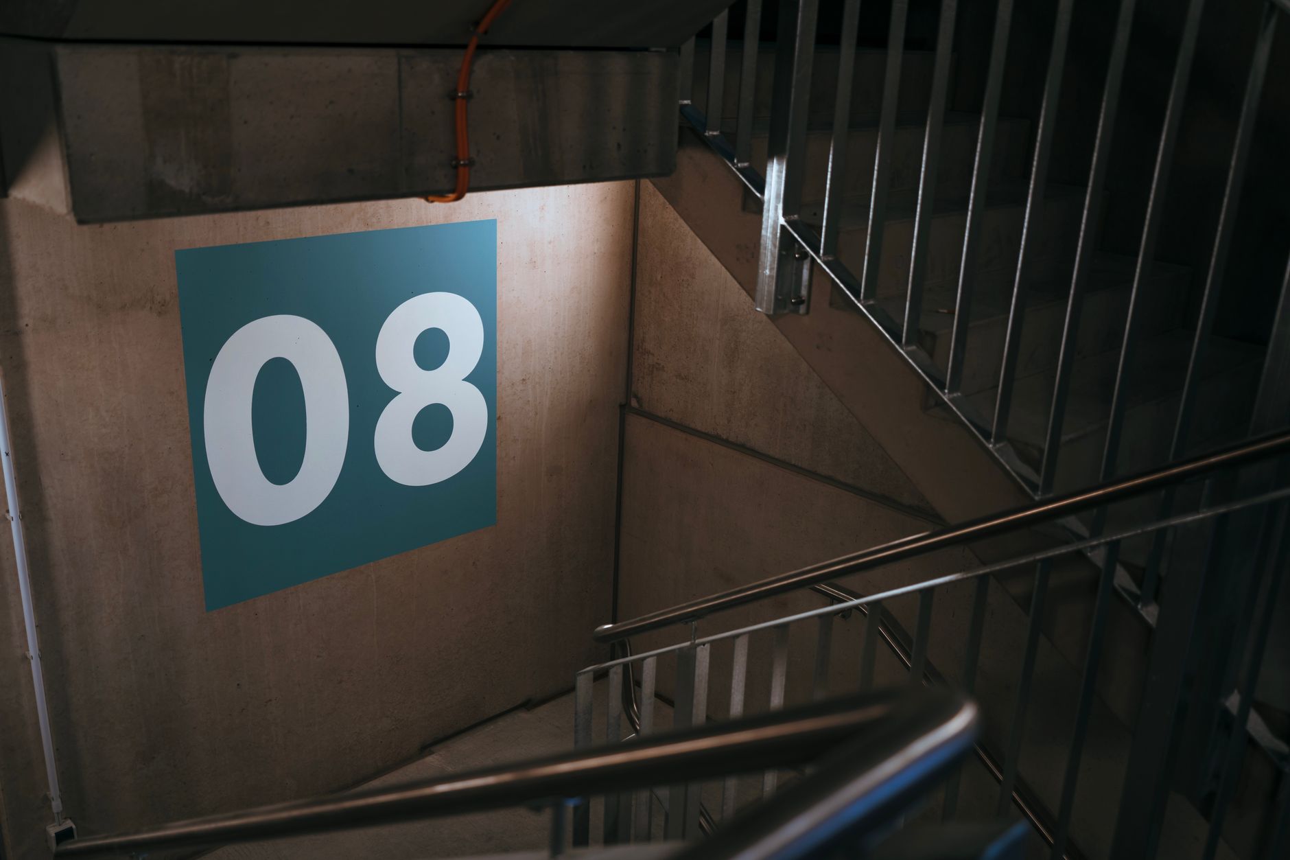 An interior stairwell where mobile inspection routes must reach fixtures on landings.