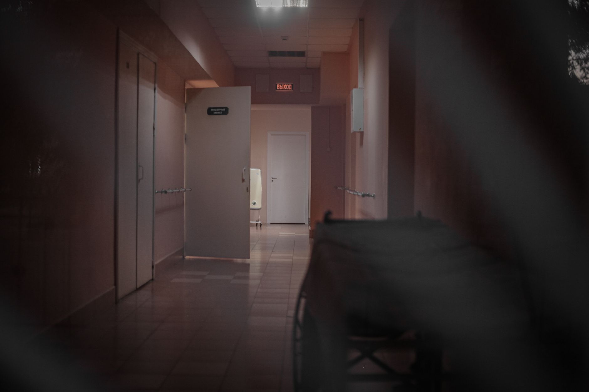 A quiet hospital corridor outside patient rooms where environmental rounds can be performed.