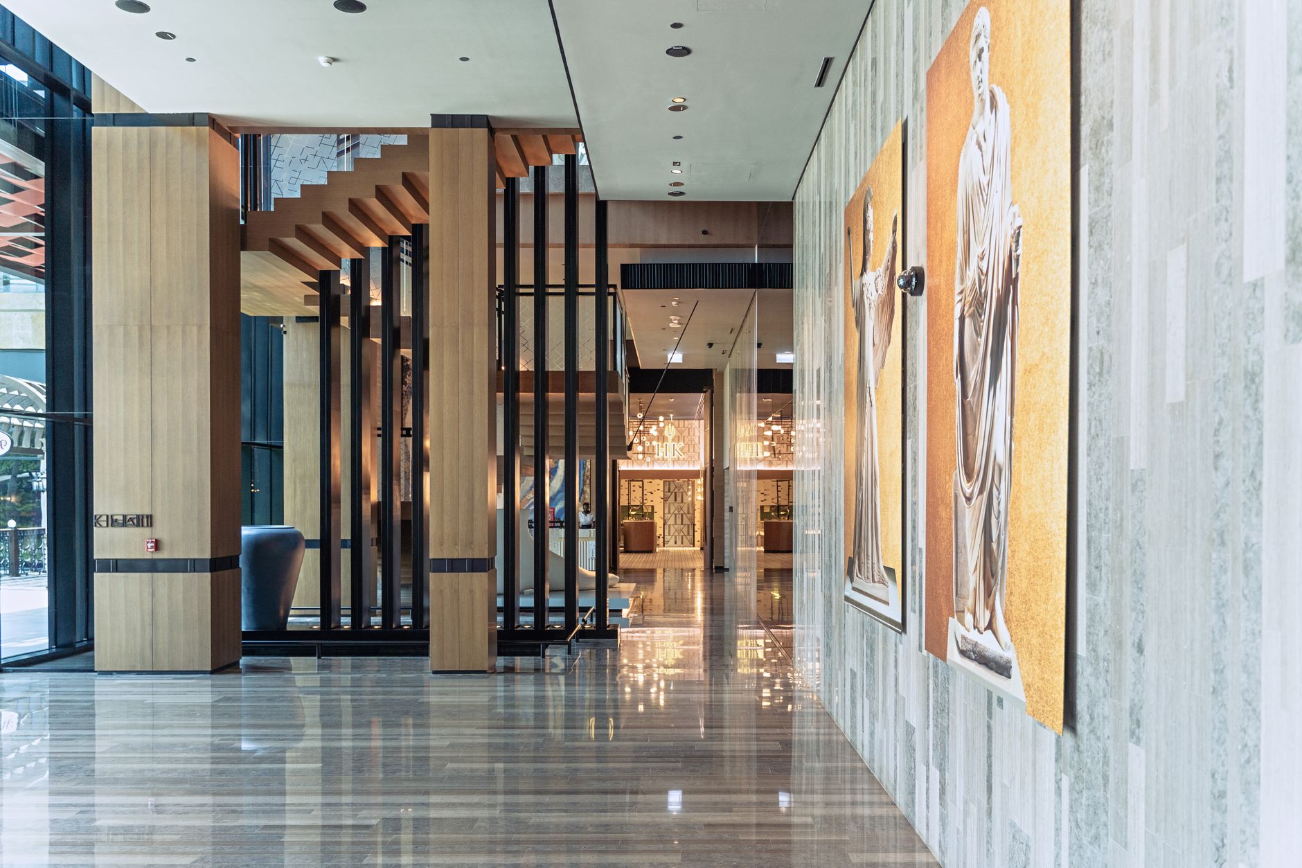 Wide view of a luxury casino resort lobby with tall ceilings and polished floors