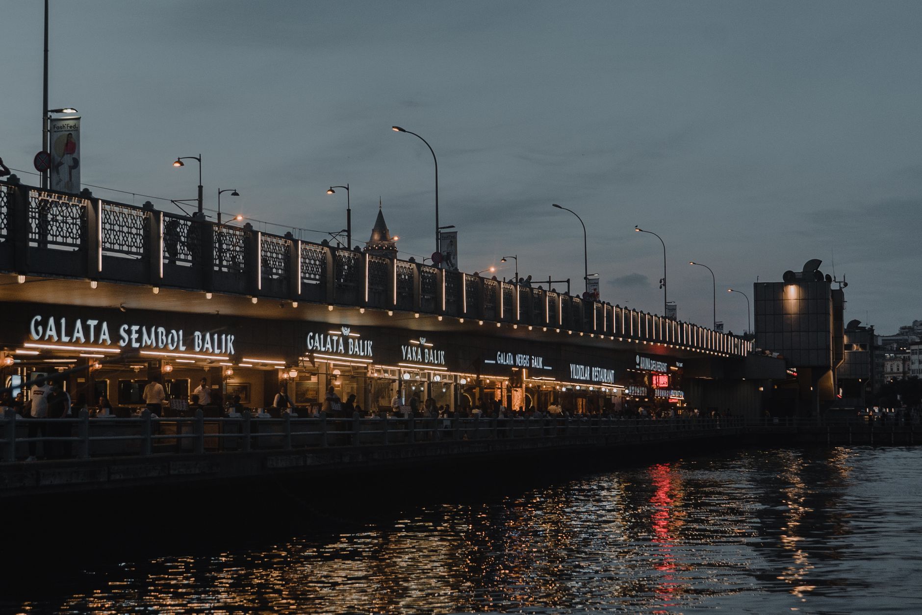 A compact waterfront retail street with festival-week foot traffic.