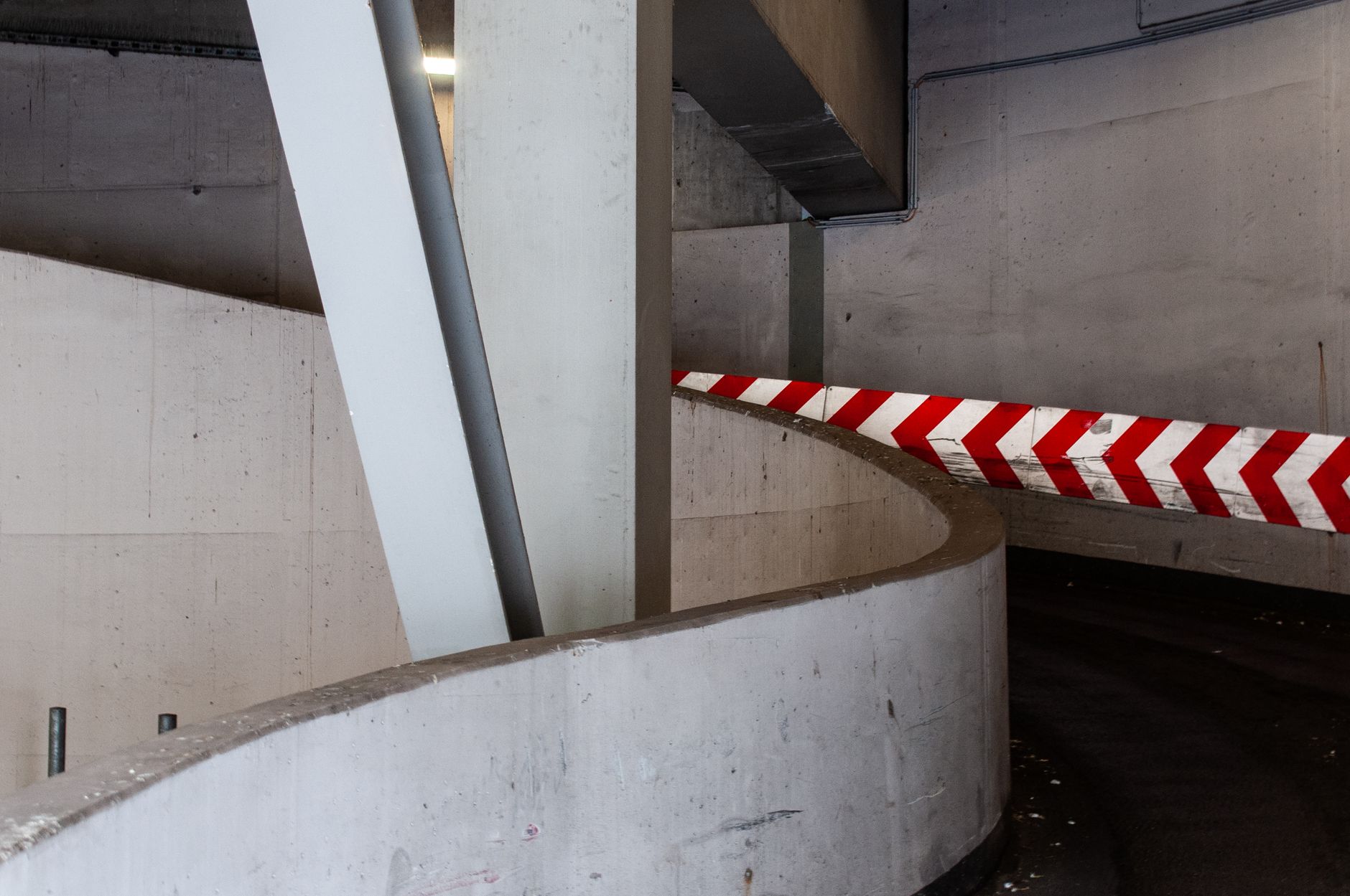 Parking structure lanes where sand and meltwater collect before elevators to the lodge.