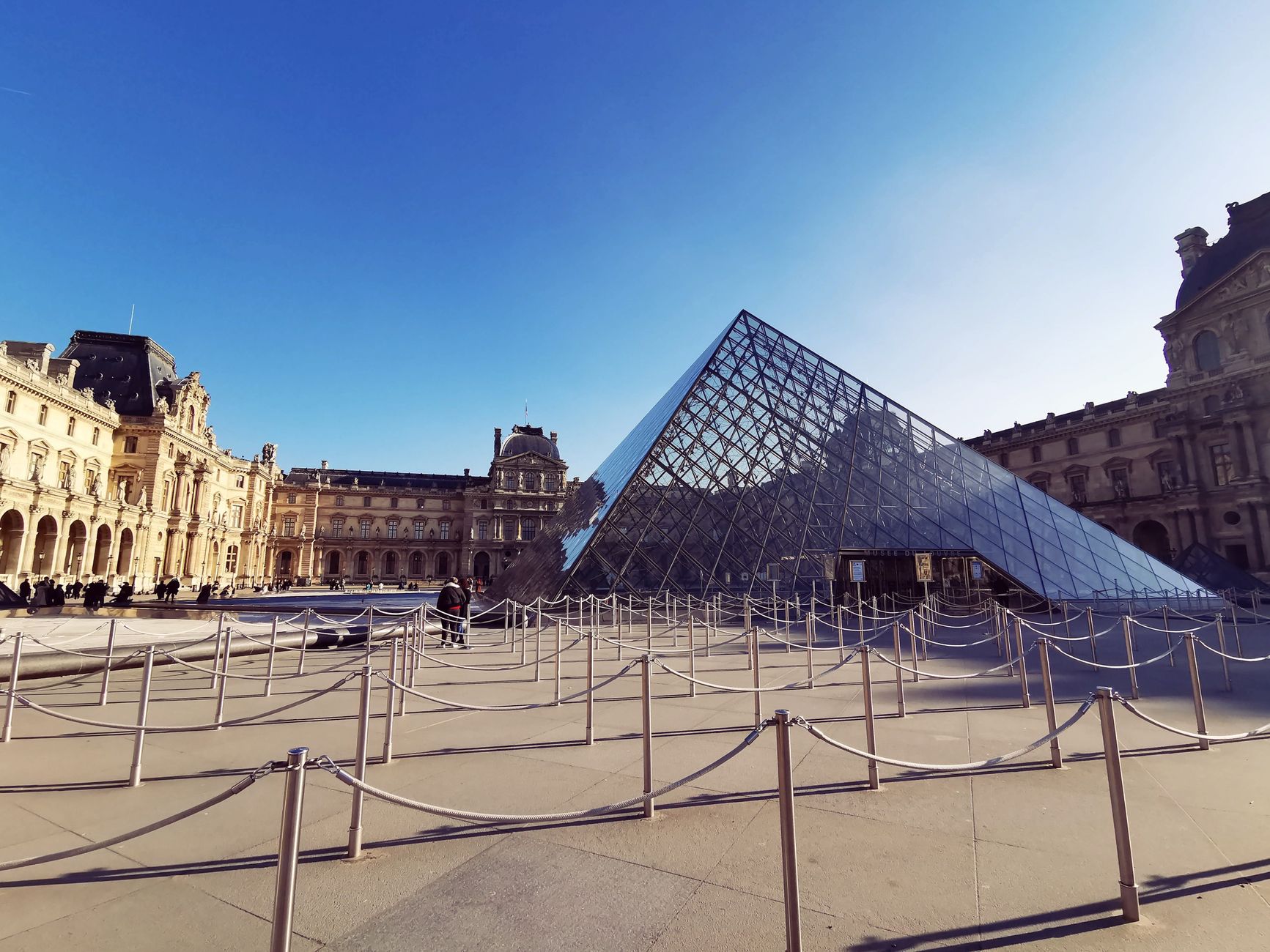 Stanchions and ropes mark a narrow path through a museum exhibit where cleaning routes must be planned.